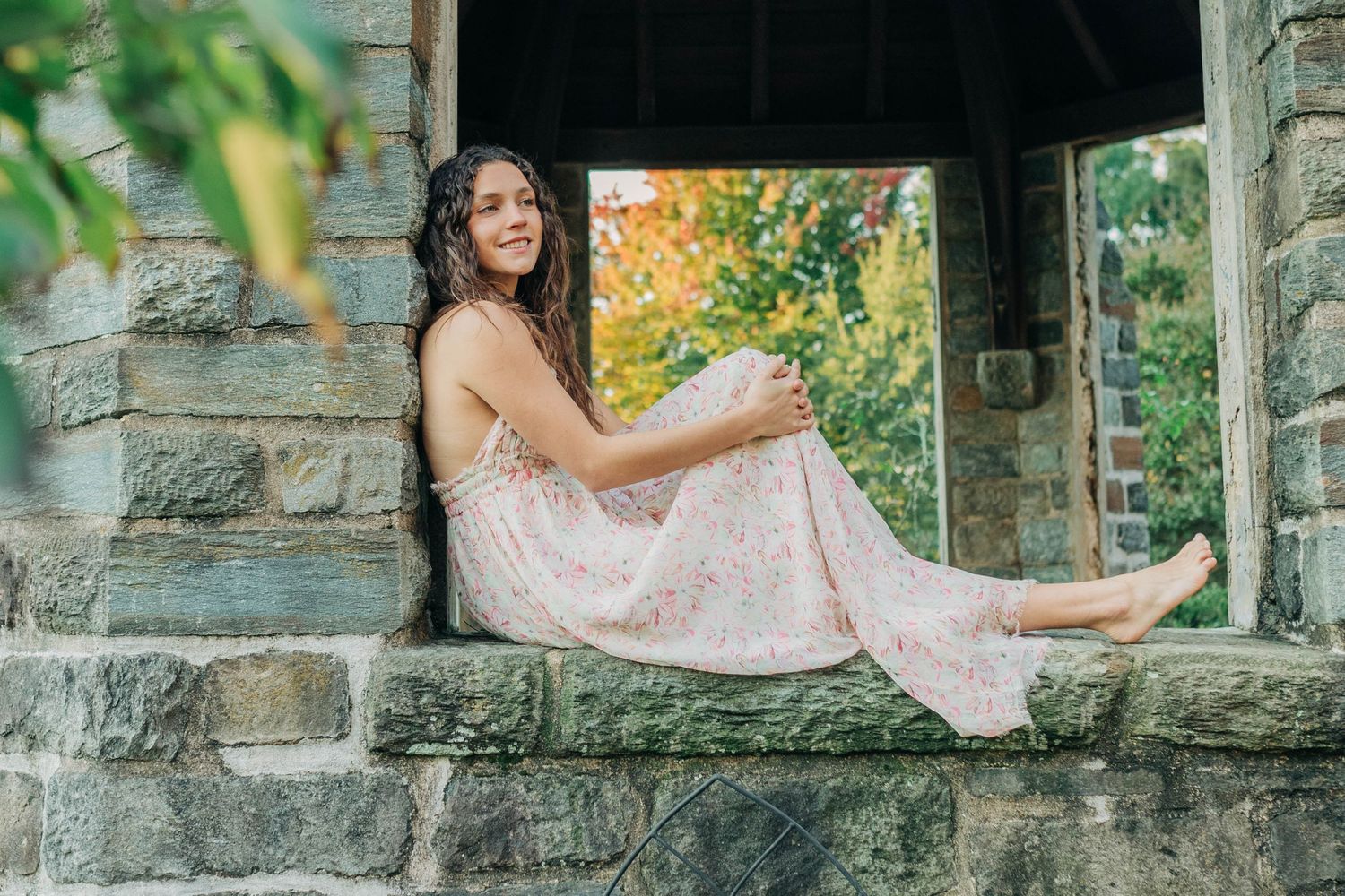 Stone archway frames a series of portrait poses in an outdoor setting.