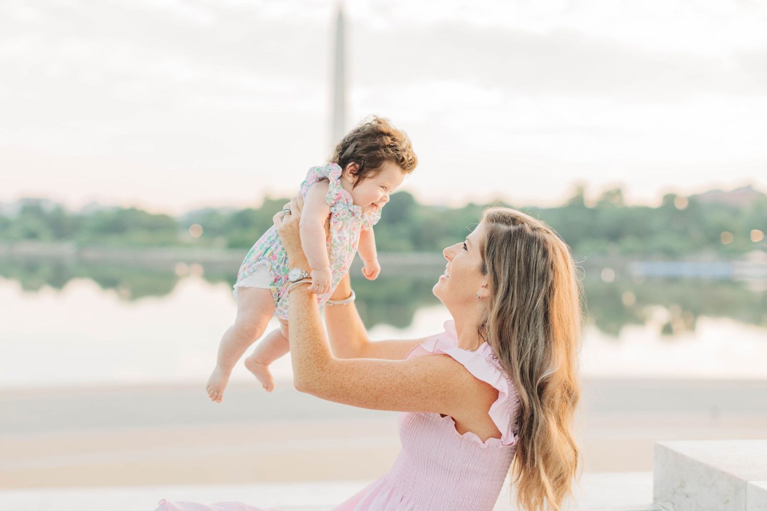 Candid family moments captured on stone steps during sunset.