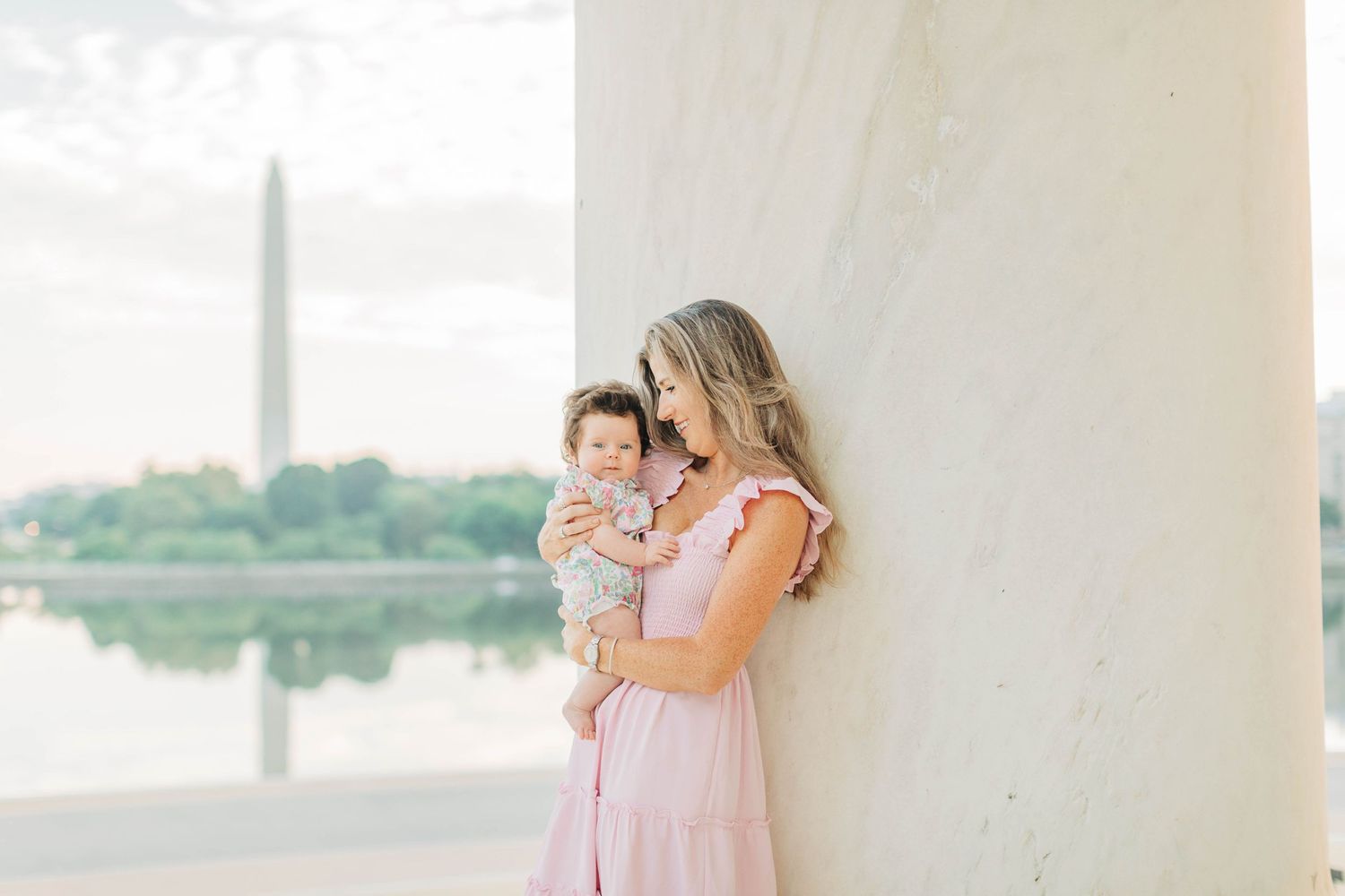 Dreamy family moment captured at the Jefferson Memorial during golden hour.