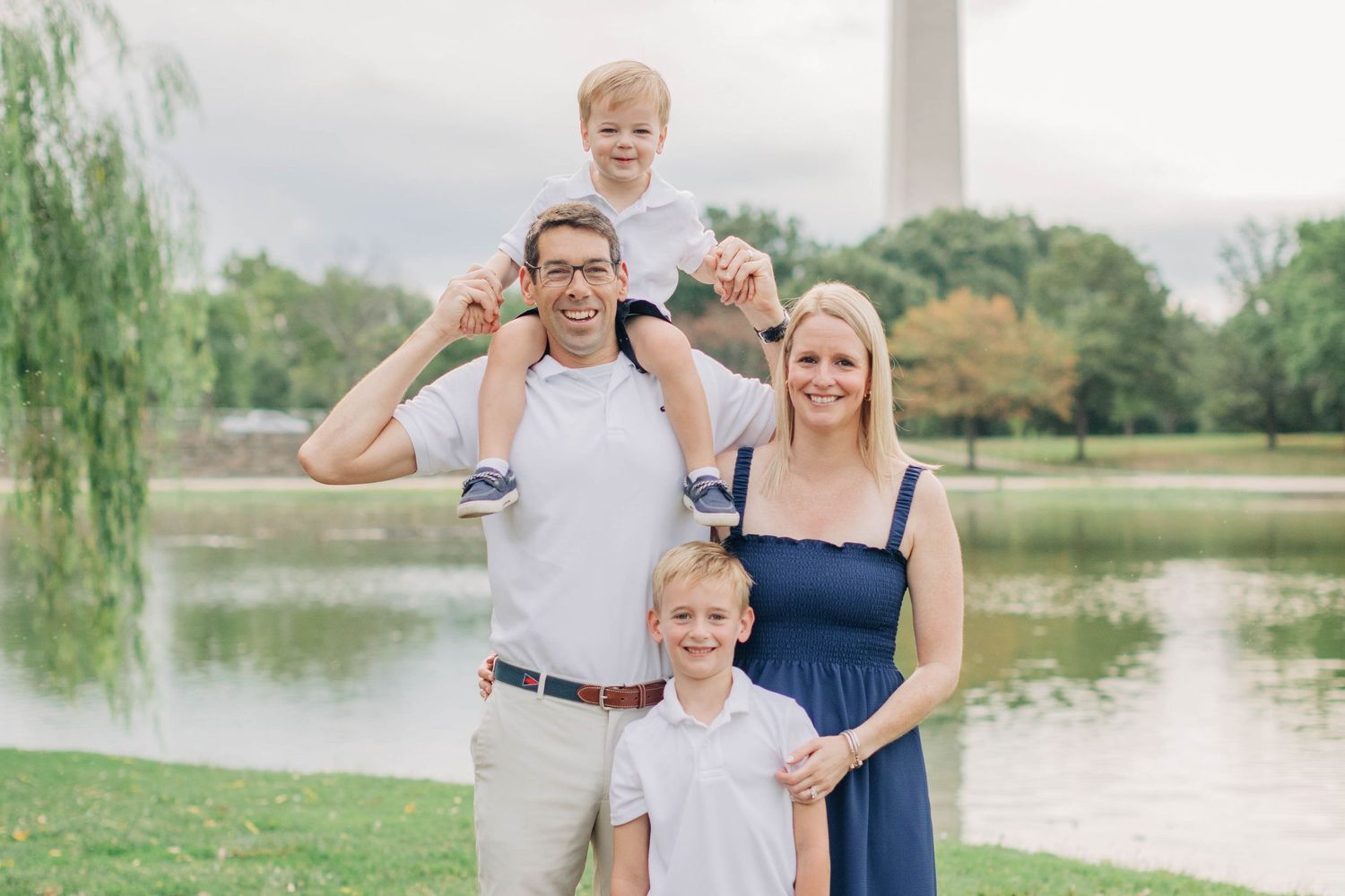 A family portrait taken at the National Mall with the Washington Monument and reflecting pool in background.