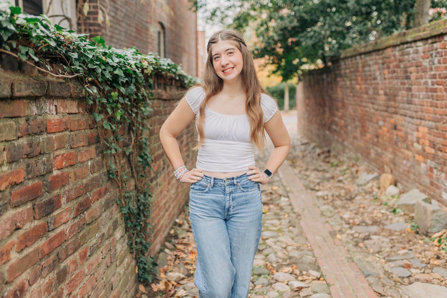Lifestyle portraits taken in an ivy-covered brick passageway.