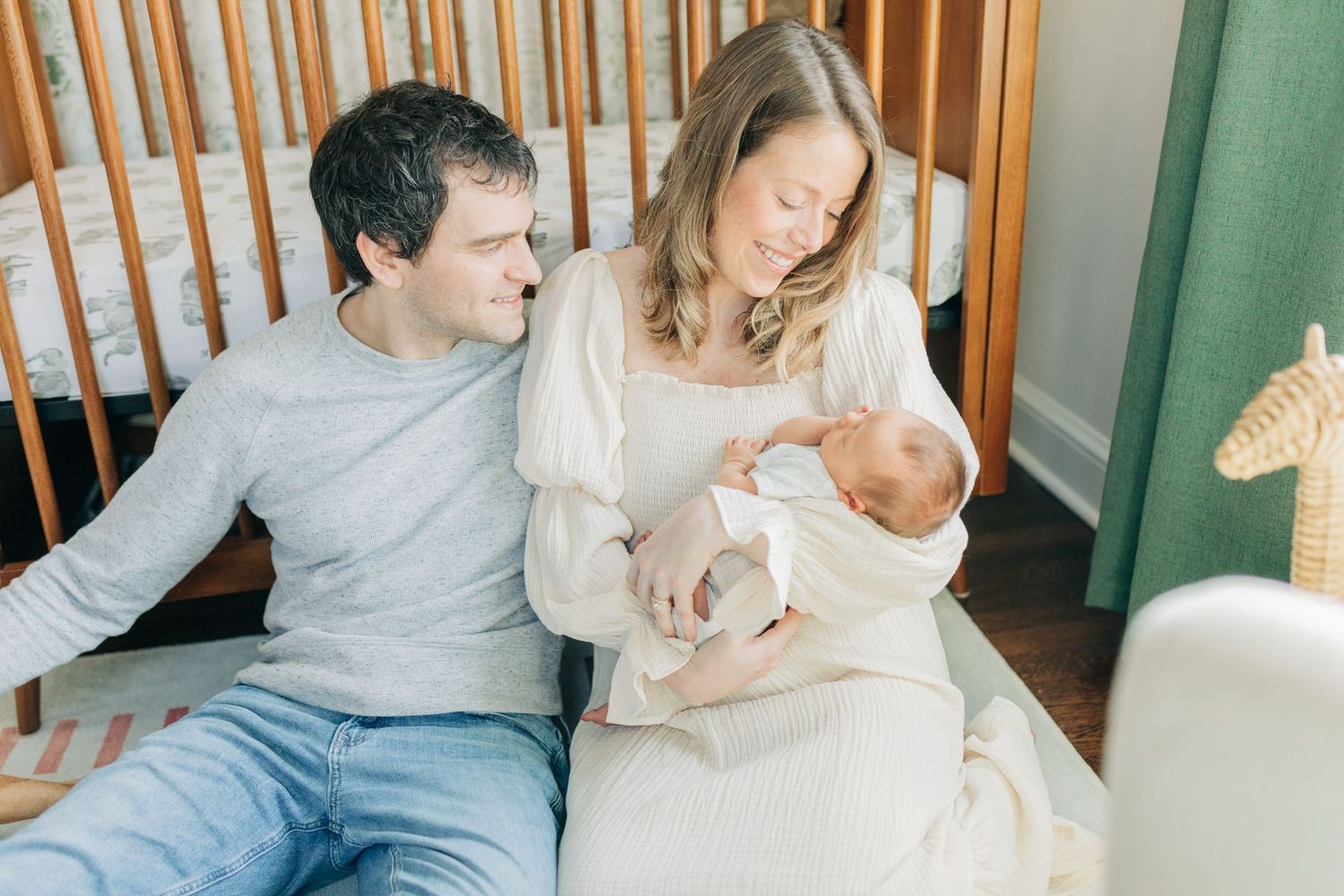 Family lifestyle photography session in bright nursery with wooden details.
