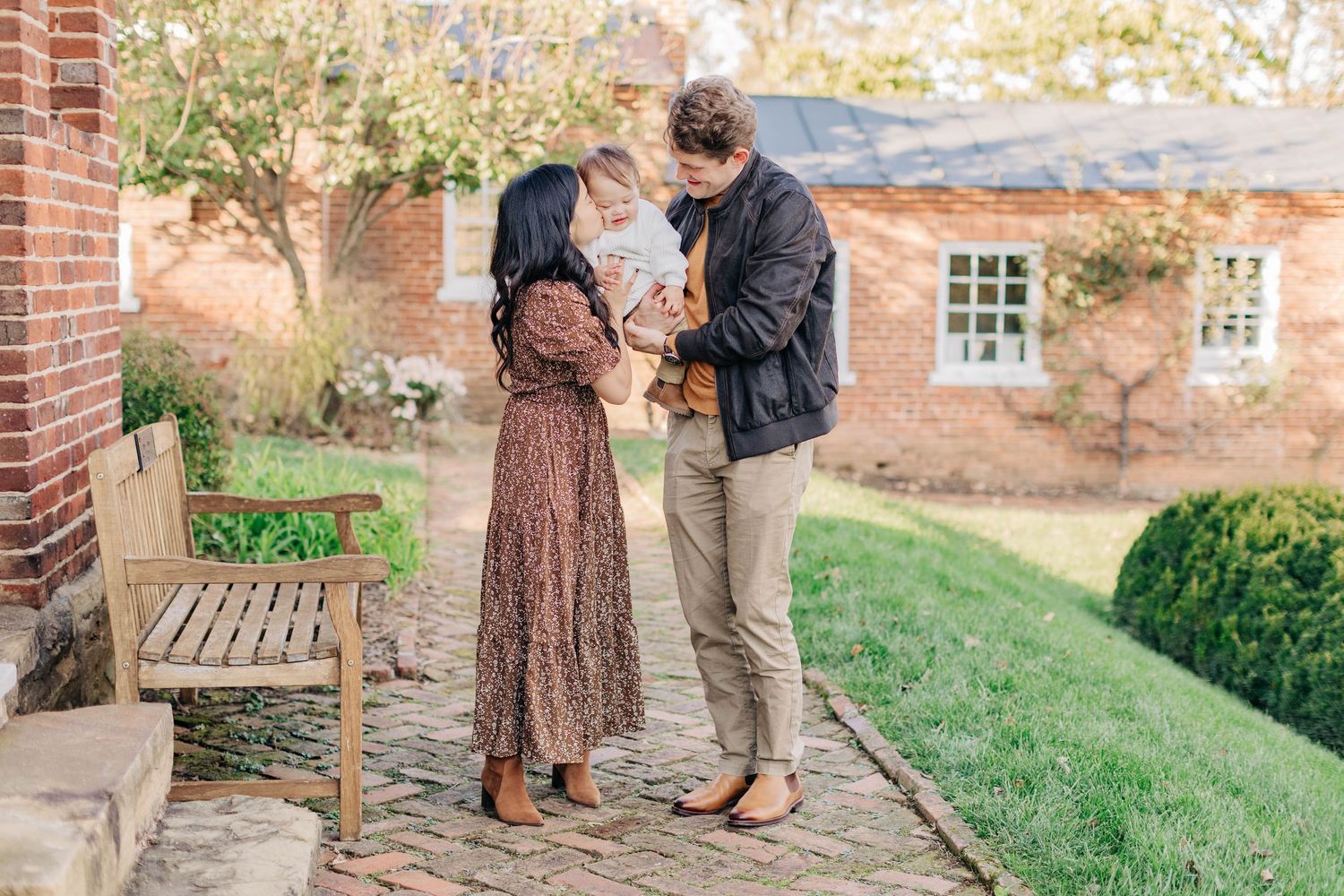 Couple walking and posing together in scenic garden setting during autumn.