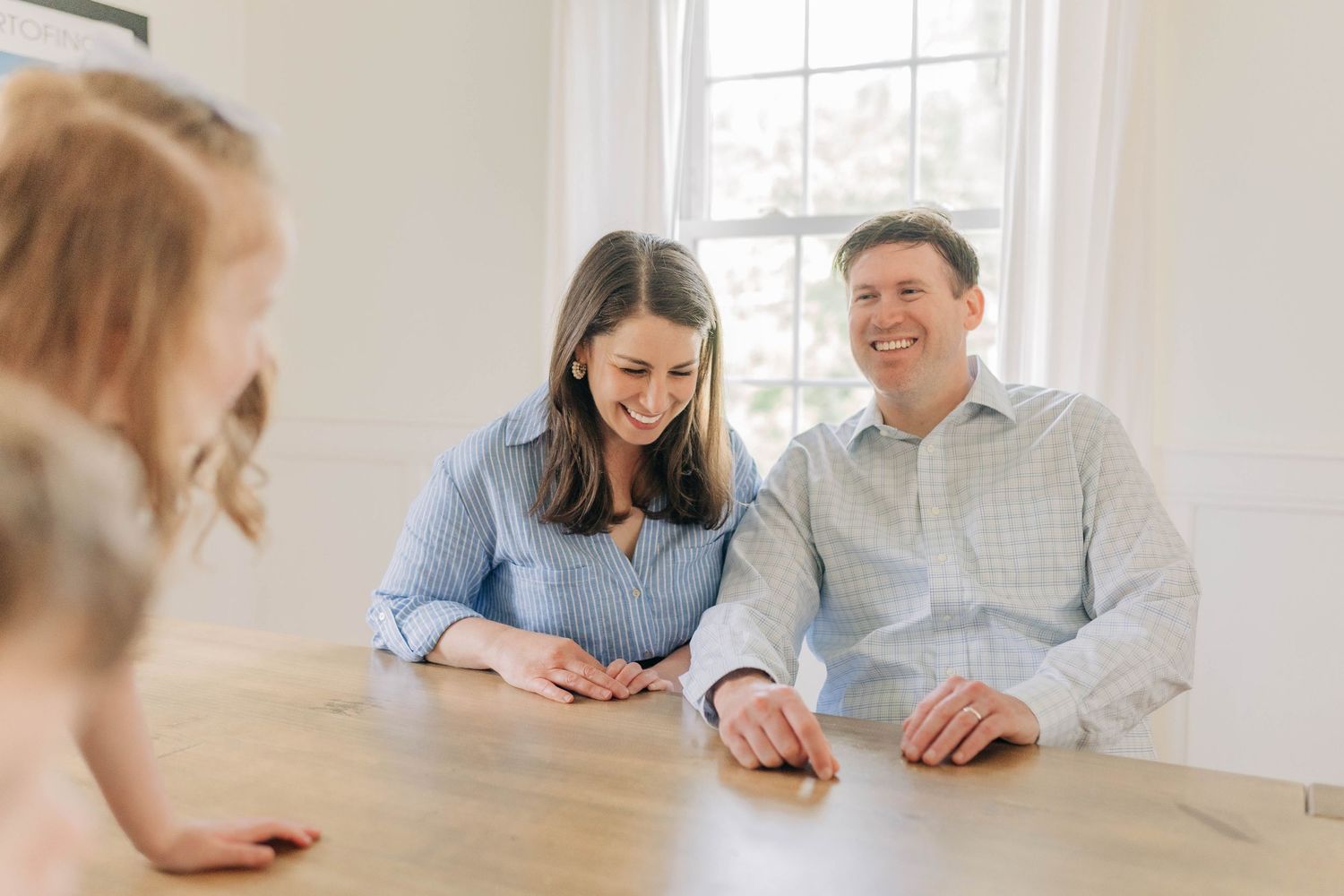 Family having a casual meeting at a bright dining table in a modern home interior.