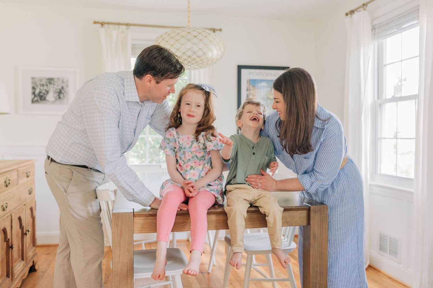 A family plays together in a bright indoor setting with natural light streaming through windows.