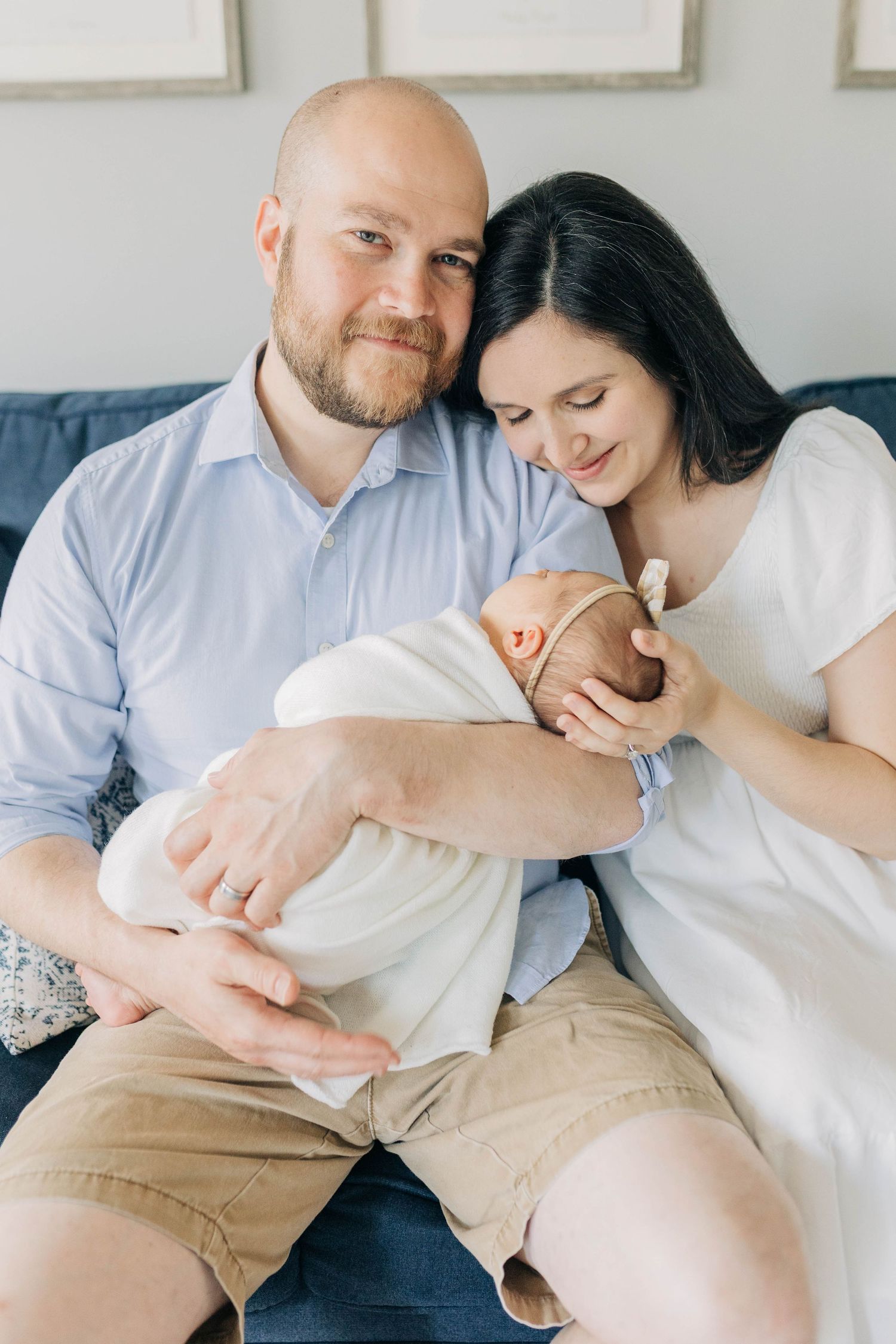 Candid family moments captured on a comfortable couch in a bright, modern living room.