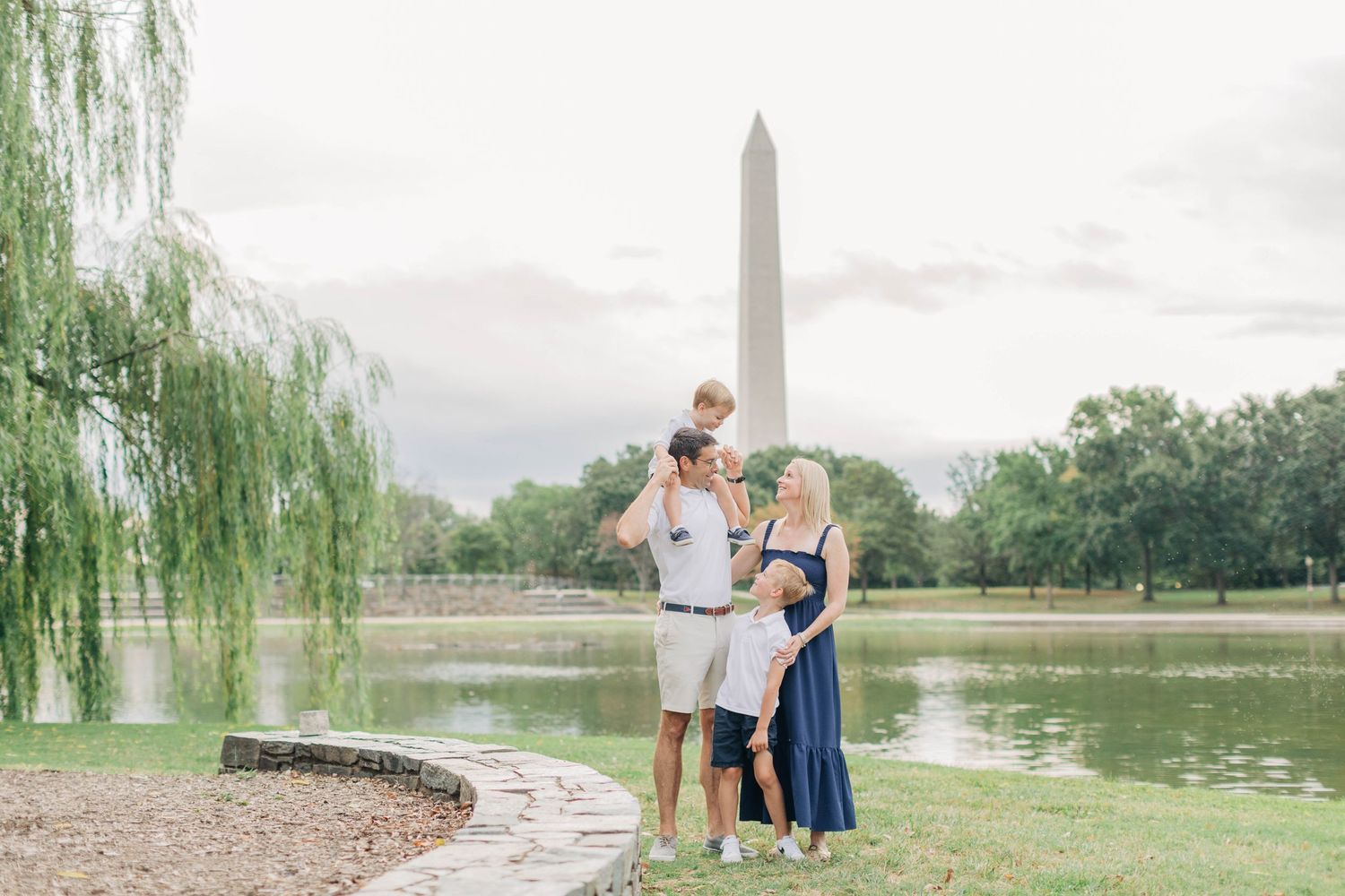 Family photos being taken near the Washington Monument on an overcast autumn day.
