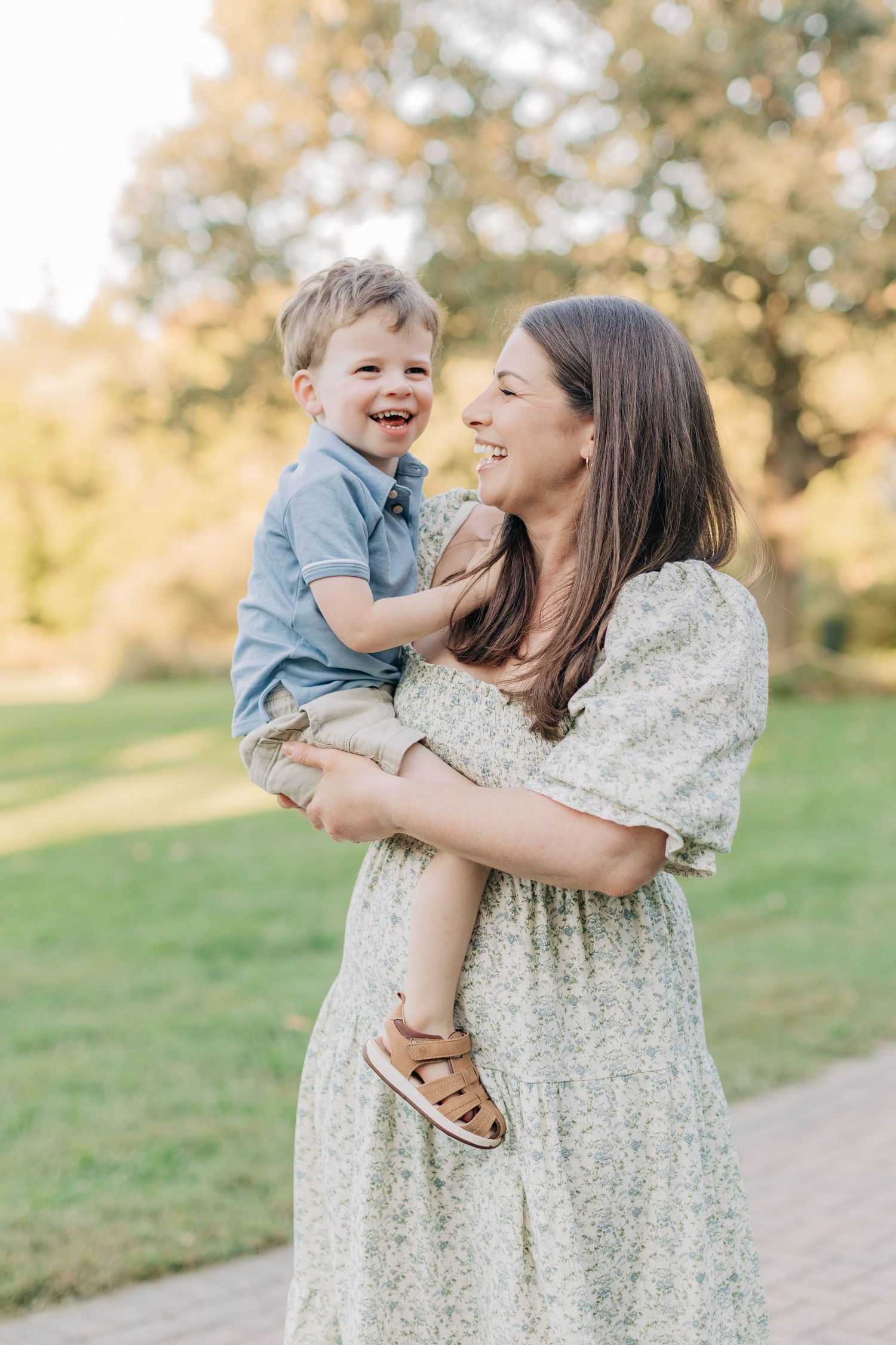 A tender moment shared between parent and child outdoors in a sunny garden setting.