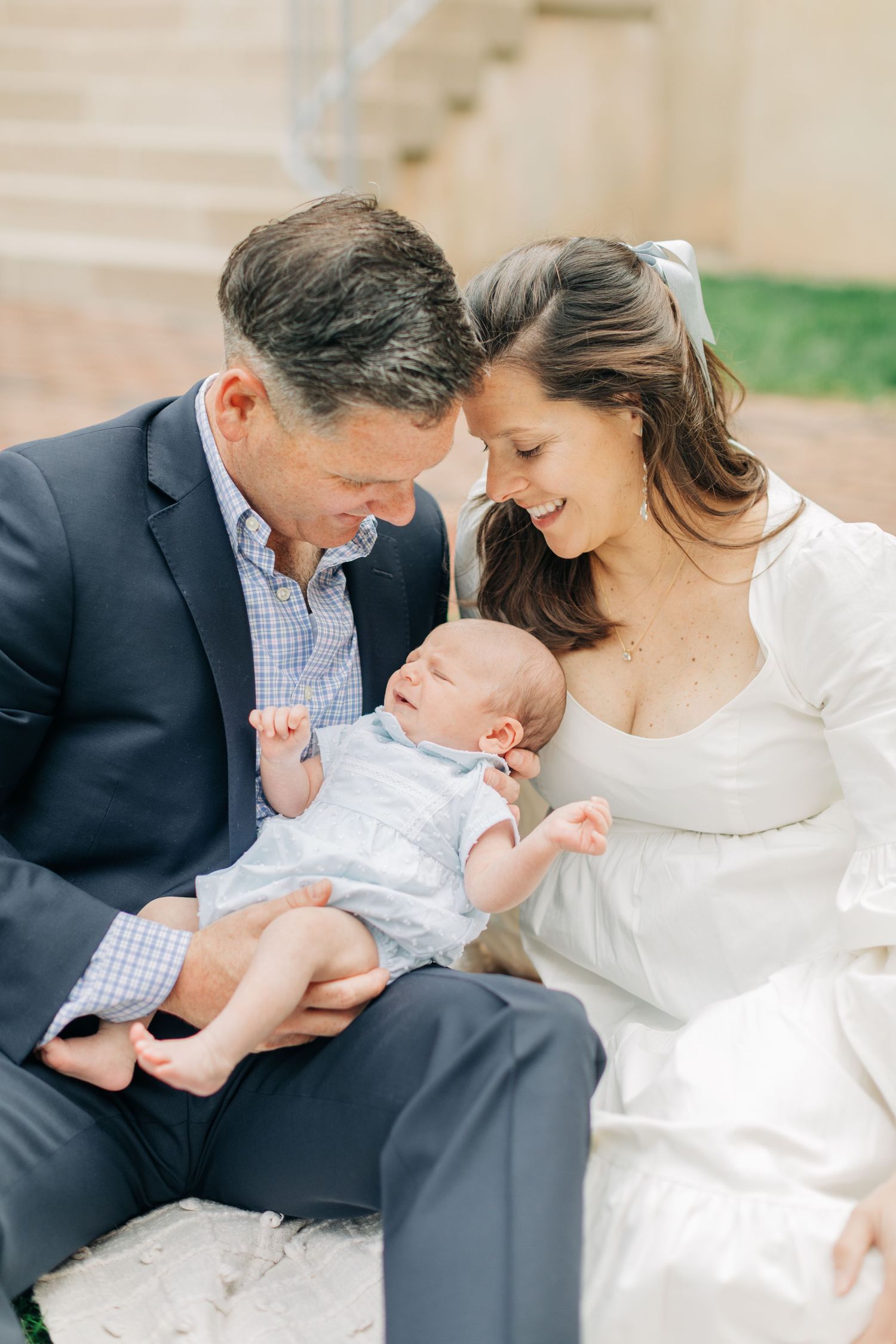 Sweet family moment captured during outdoor photo session.