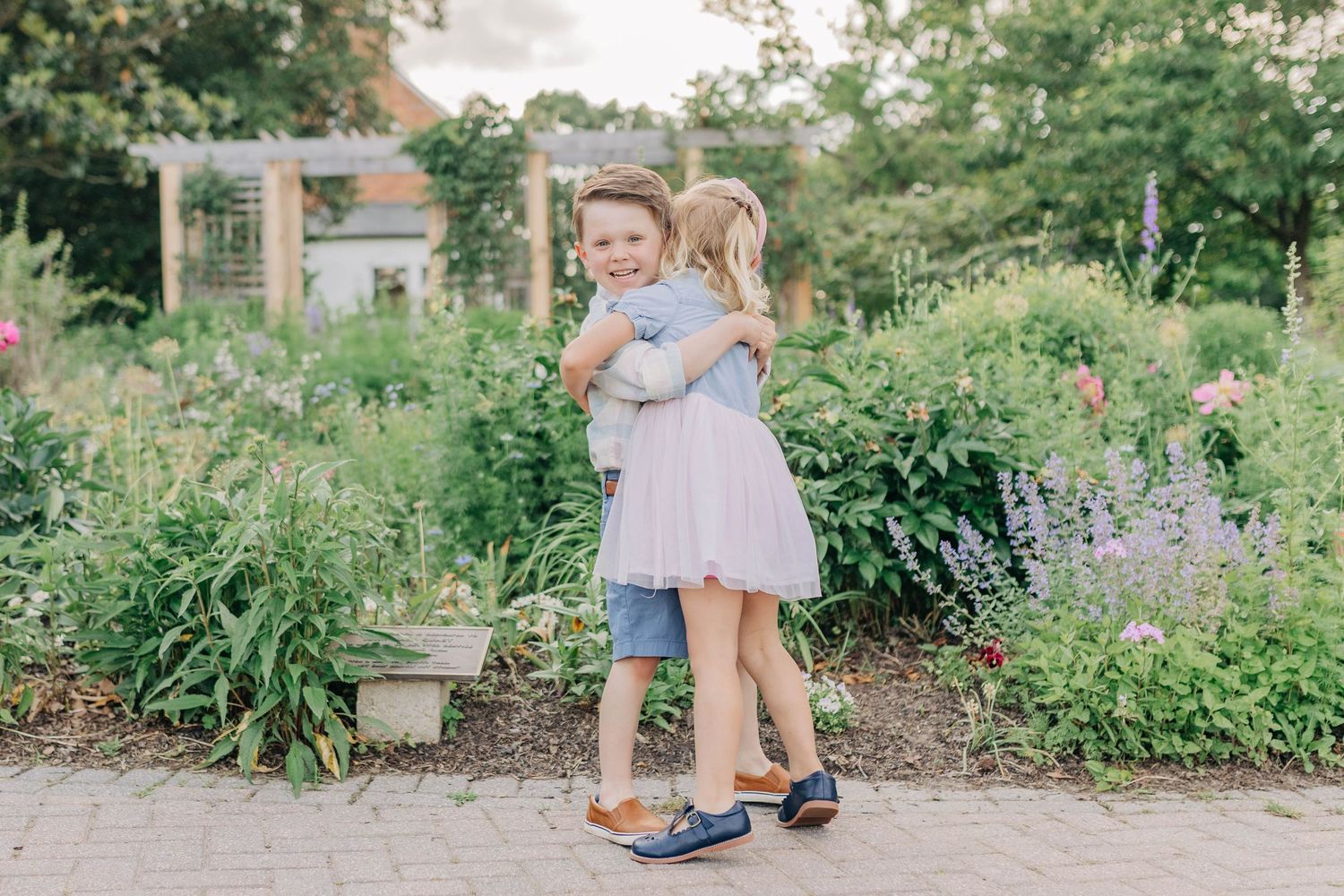 Family photoshoot in a lush garden setting with natural landscaping.