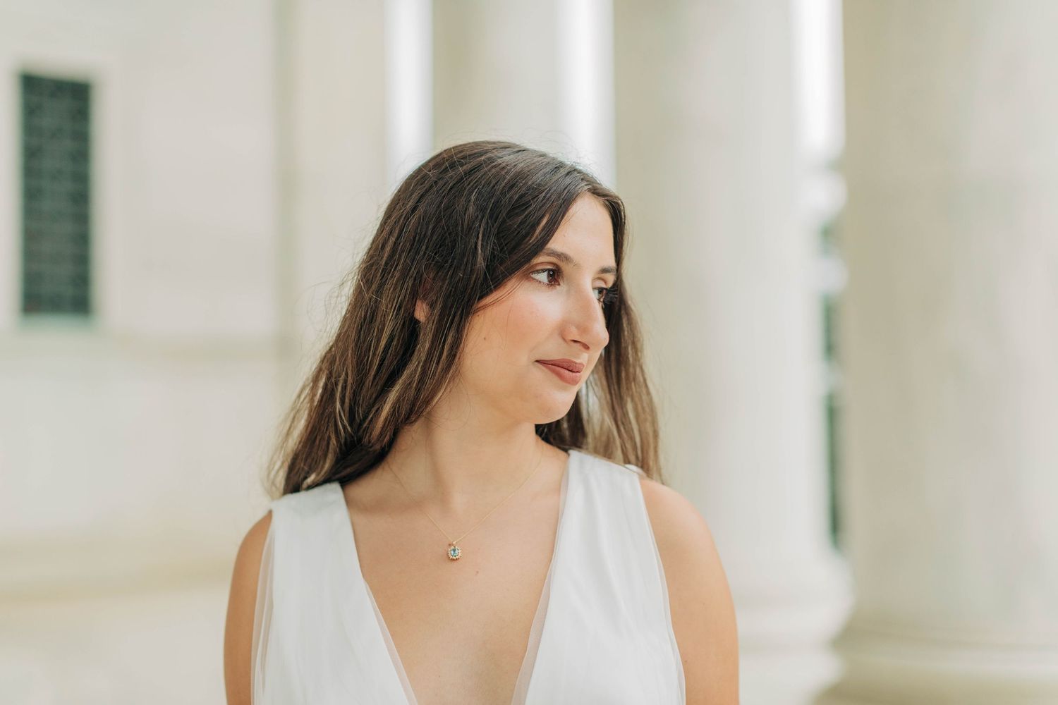 Elegant portraits taken against a backdrop of classical white architecture.