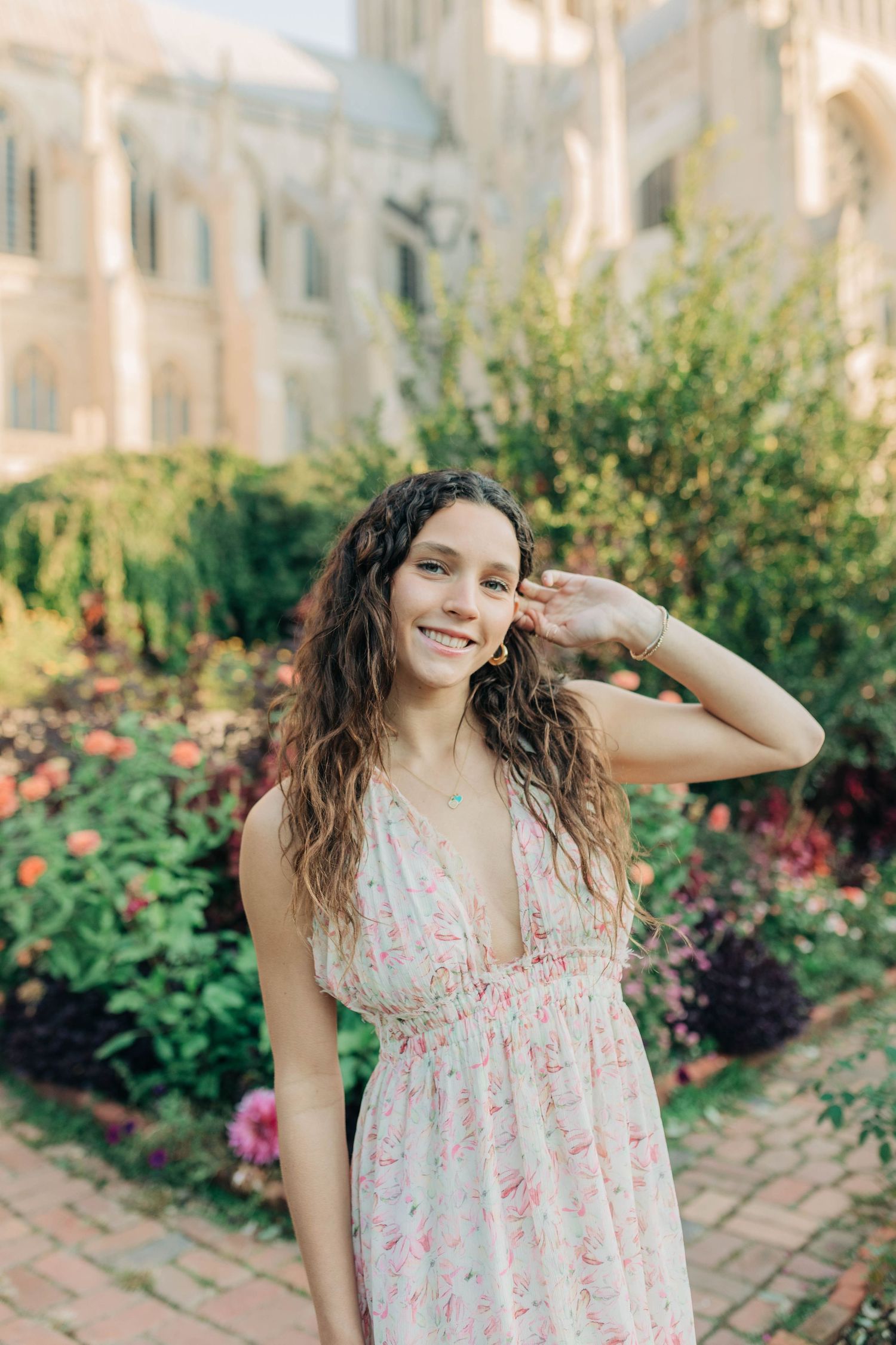 Garden setting with blooming flowers and brick pathways creates a romantic backdrop for portraits.