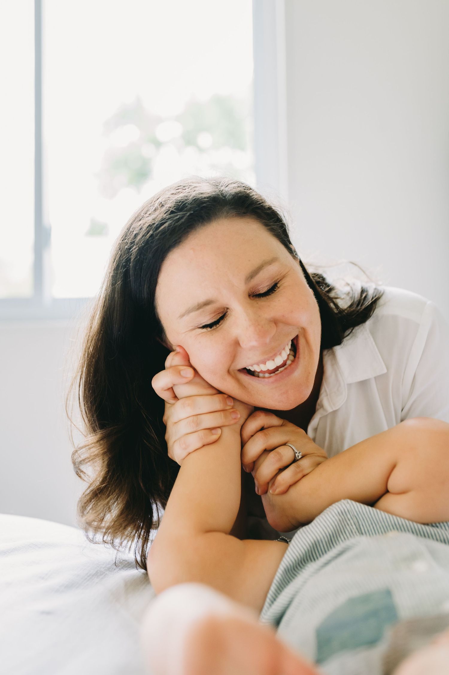 Candid lifestyle photos showing joyful laughter and genuine emotion in bed.