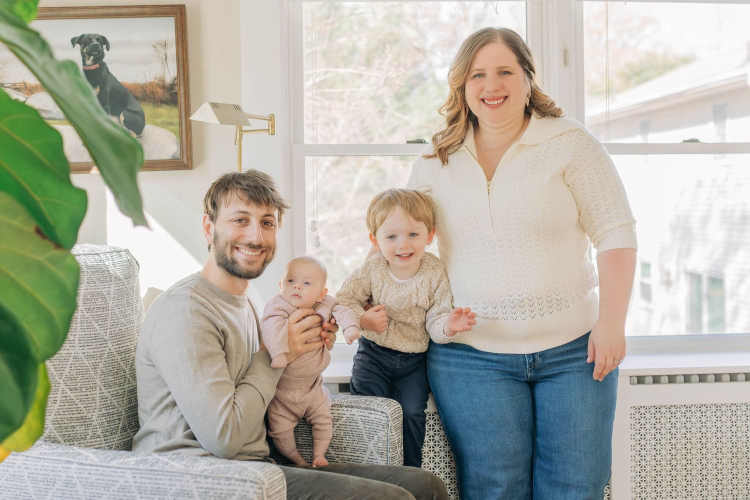 Candid family portraits in a modern living room with natural decor.