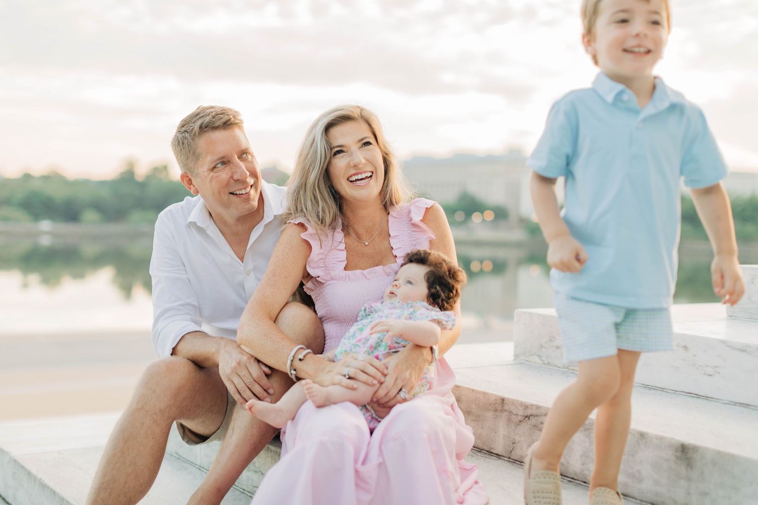 Happy family sharing joyful moments during outdoor photo session near Washington Monument.