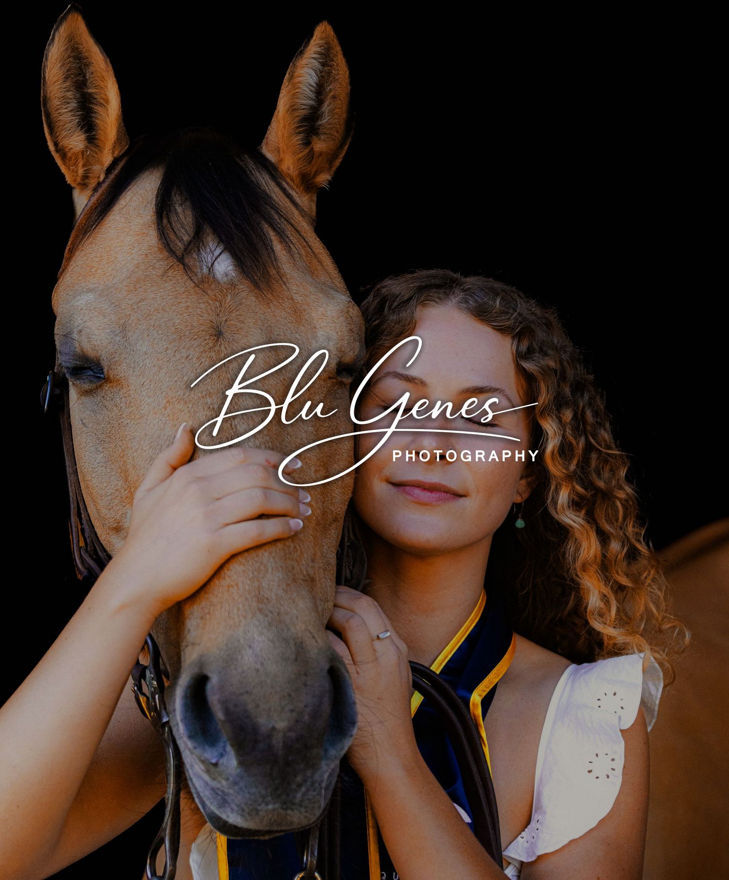 Curly-haired young woman holding a palomino horse's face close to hers, Blu Genes Photography branding.