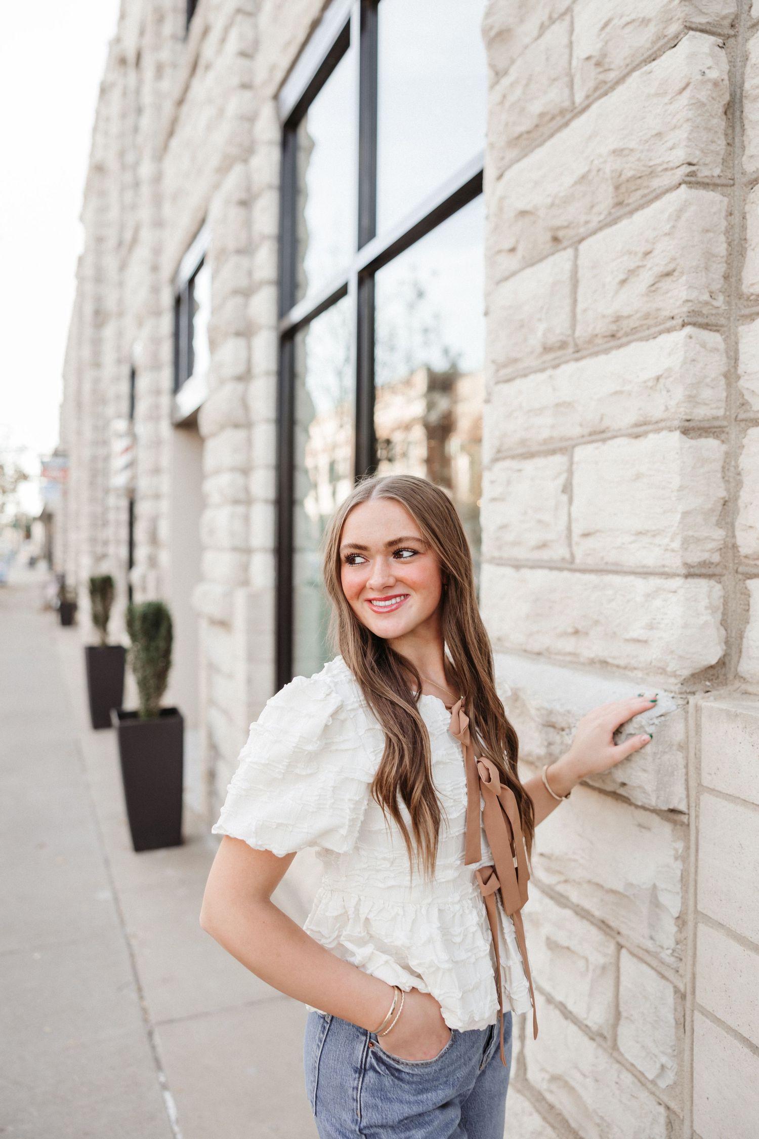 Casual portraits against textured limestone wall.