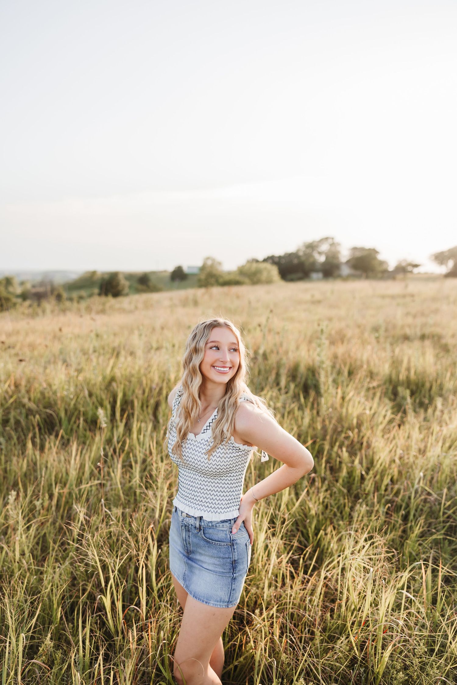 Candid shots in a golden field at sunset wearing casual summer clothing.