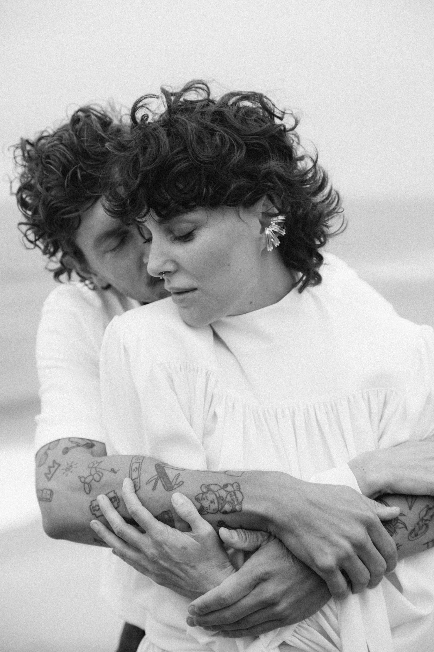 Artistic black and white close-up shots showing intimate embrace.