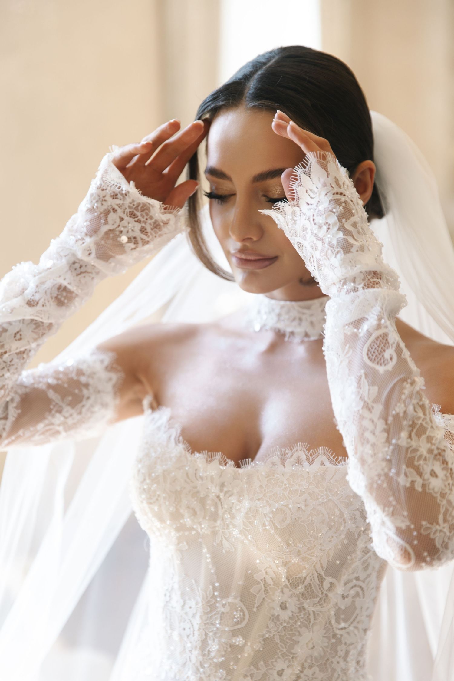Close-up shots of delicate lace details on a white wedding dress with long sleeves.