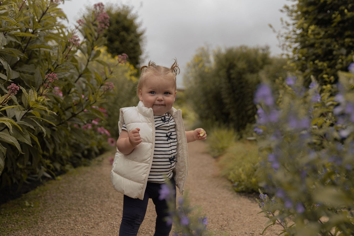 baby walking around a greenhouse