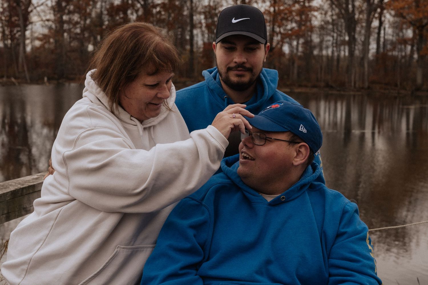 family of three by lake
