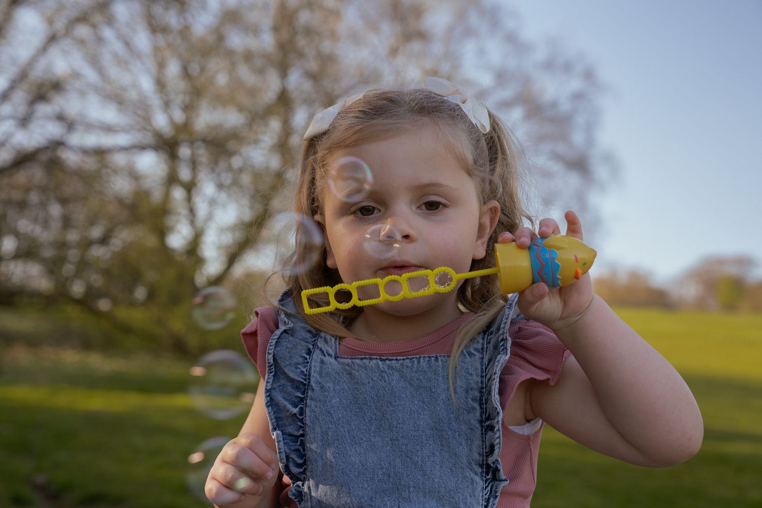little girl blowing bubbles
