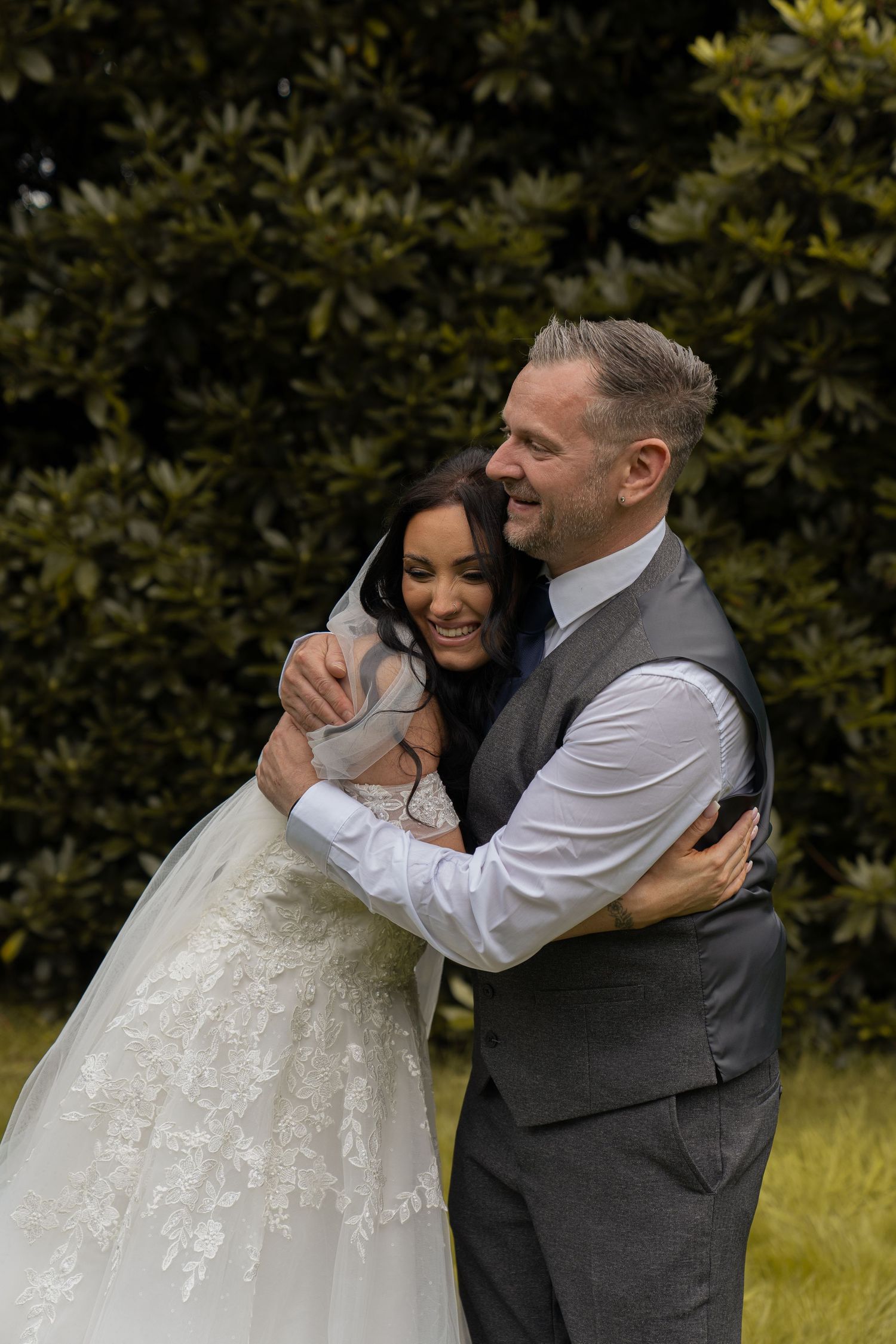 father of bride and bride hugging