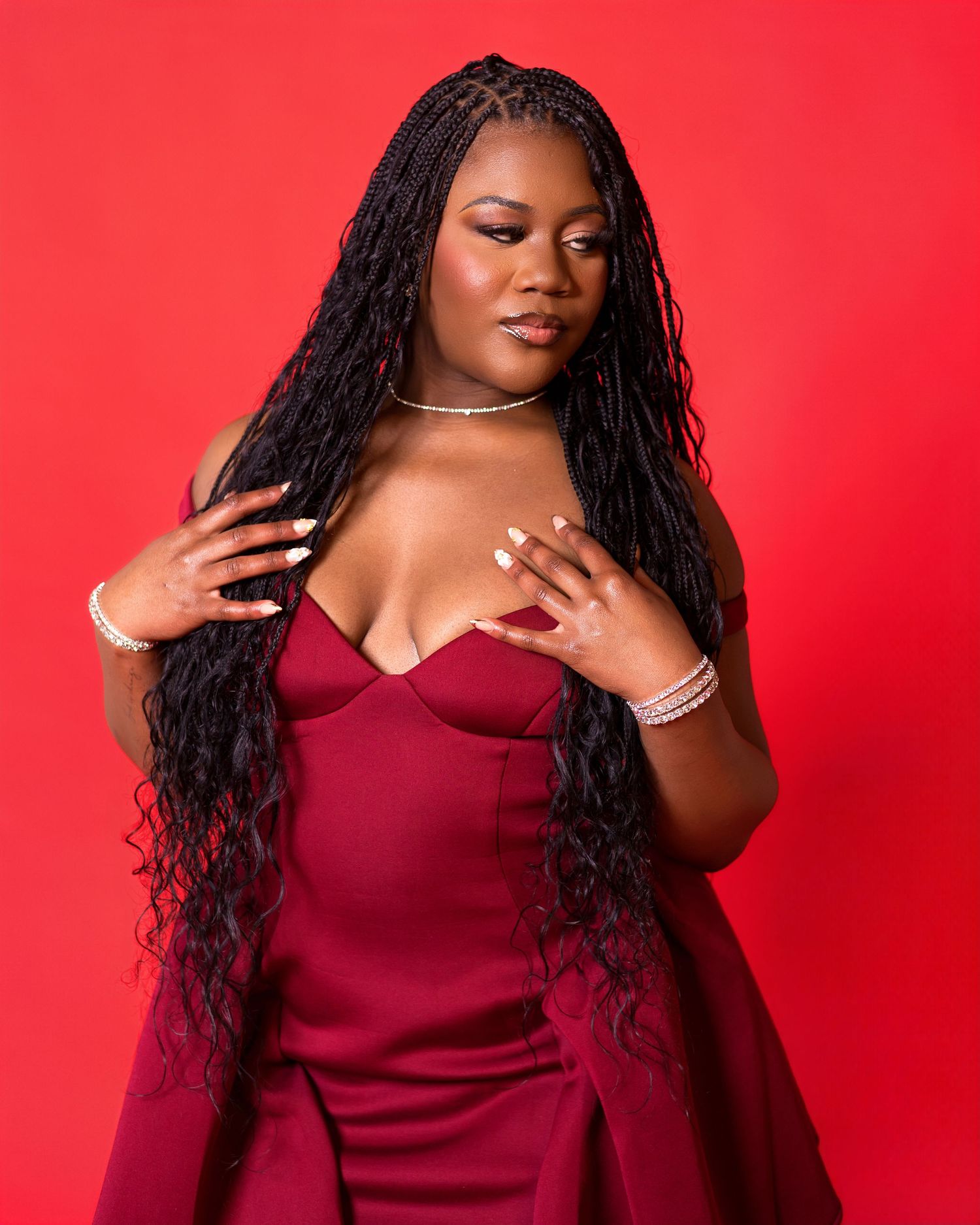 Elegant portrait series in deep burgundy clothing against a vivid red background with dramatic lighting.