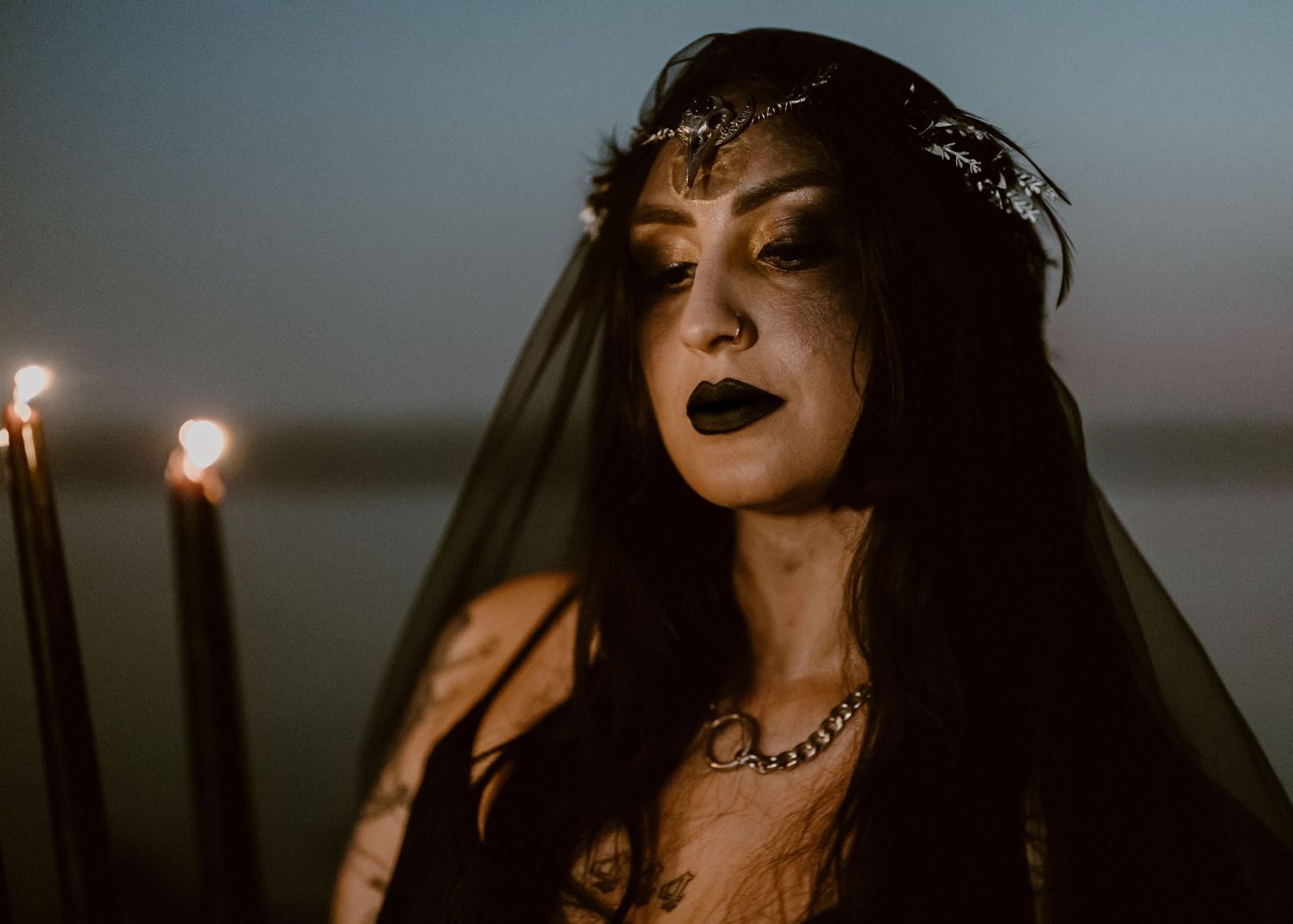 Moody candlelit portrait series with gothic styling and dark lipstick in dim lighting.