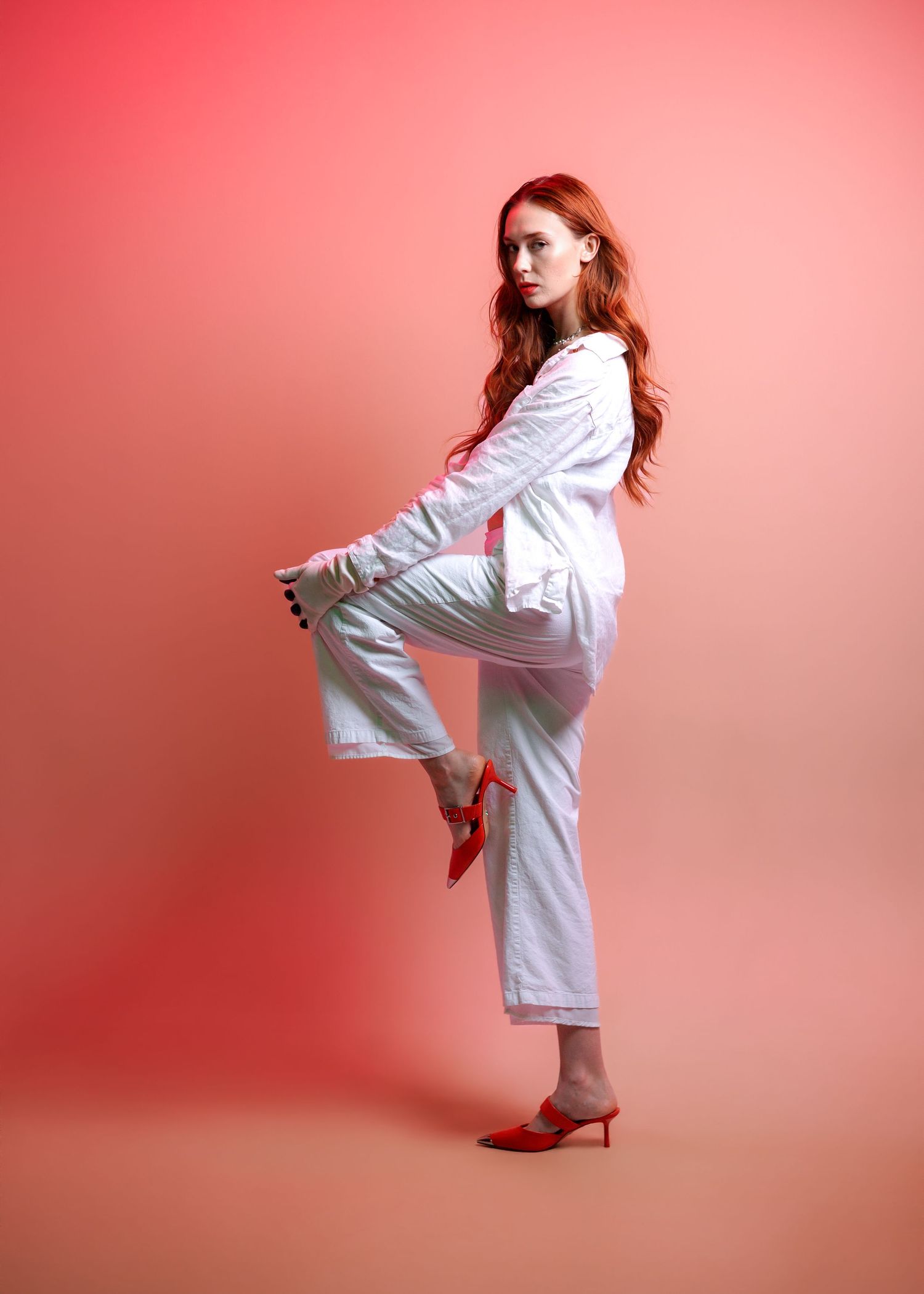A figure in a white sweater strikes dynamic poses against a pink background in a fashion photo sequence.