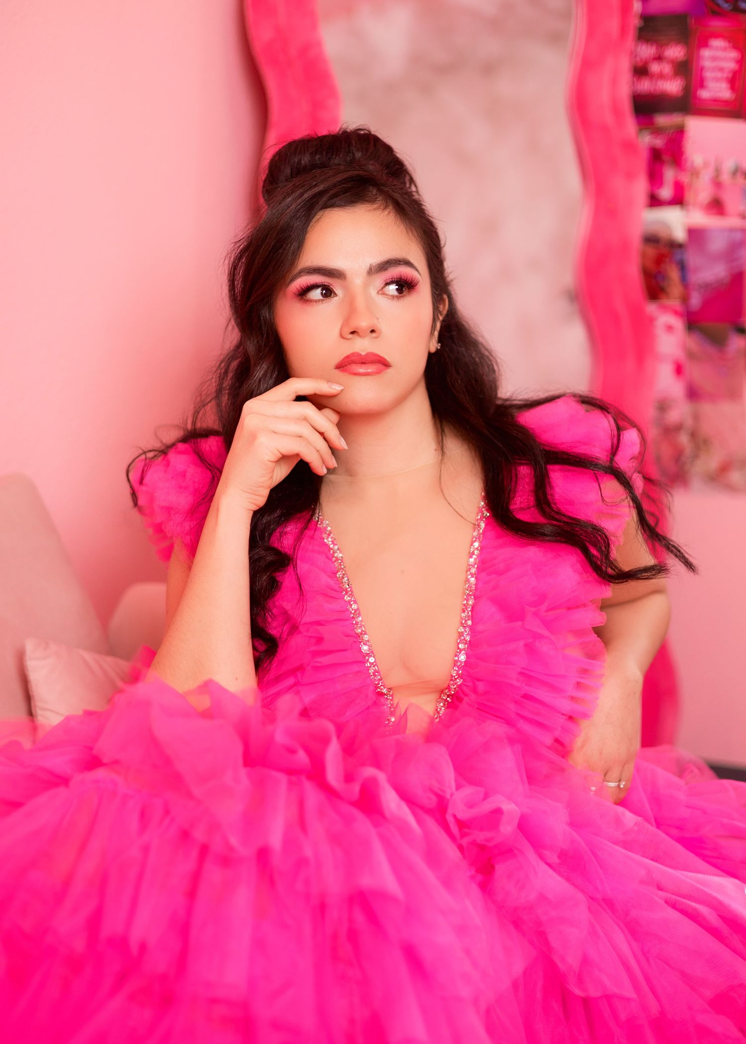 A series of fashion portraits featuring someone in a vibrant hot pink tulle gown against a pink backdrop.