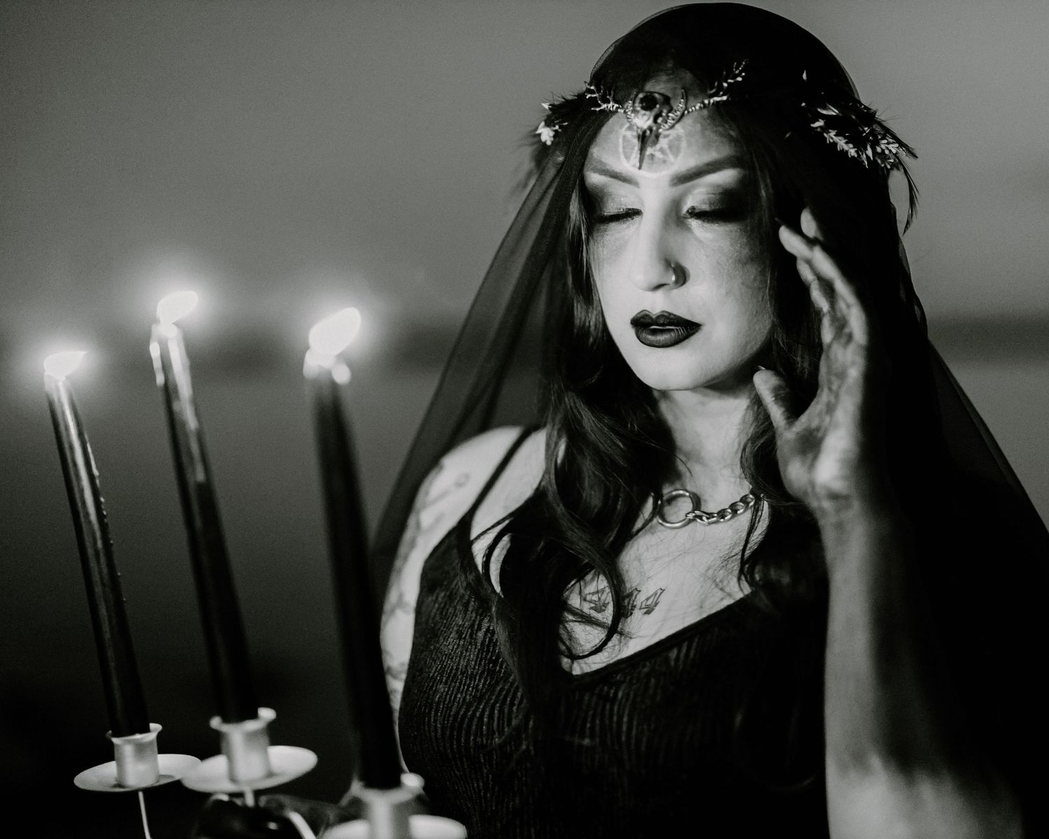 Dramatic black and white portraits featuring dark gothic bridal styling with candlelight.