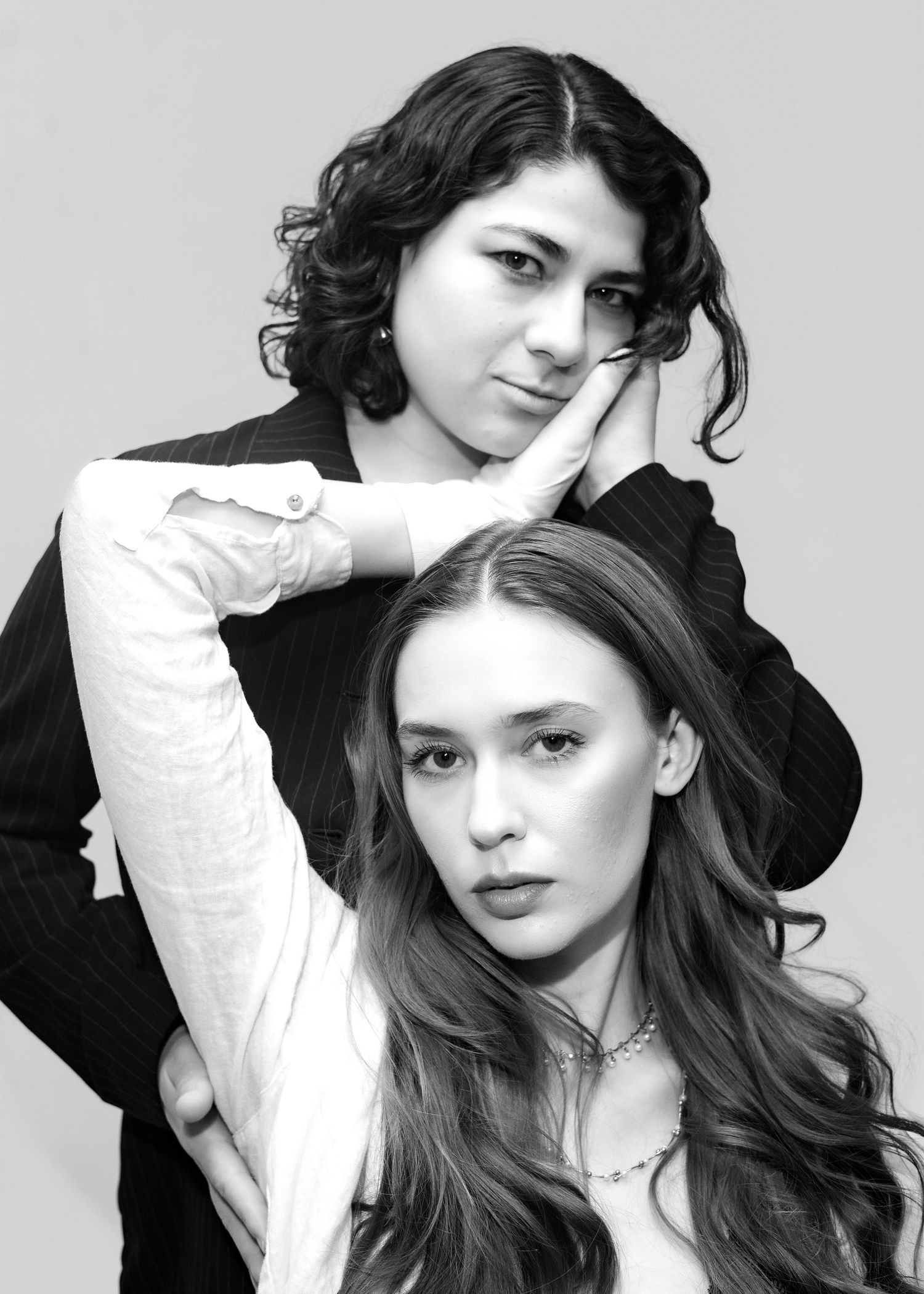 Black and white fashion portrait series showing intimate poses between two models.