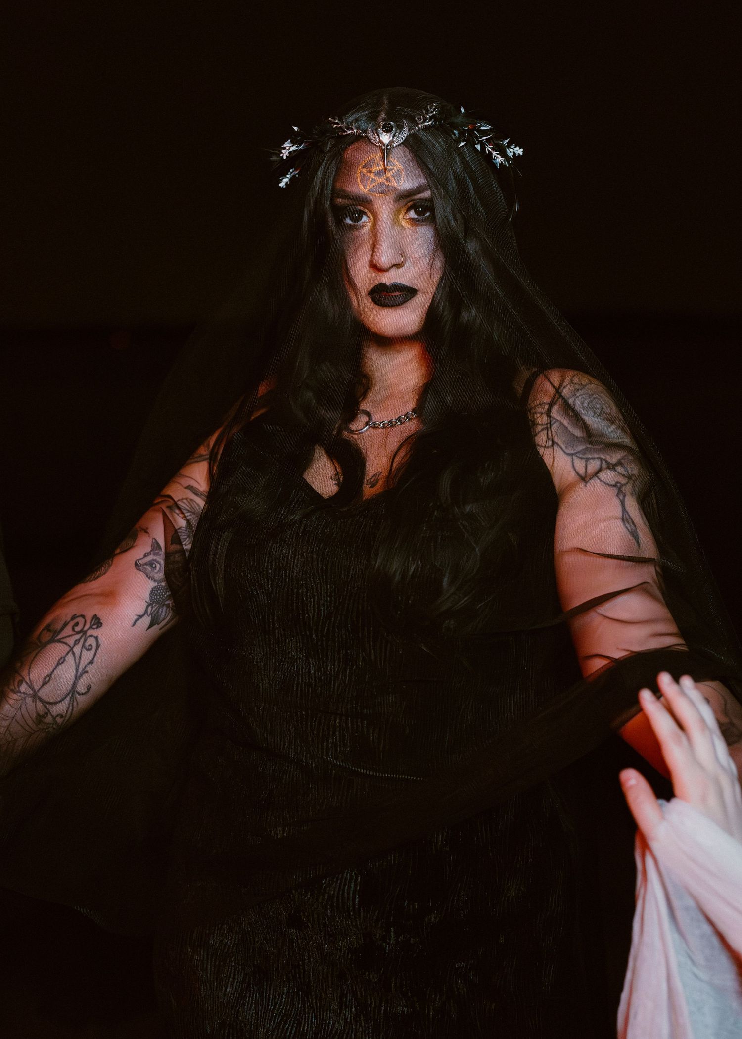 Artistic gothic portrait series showing dramatic expressions and dark makeup in low light conditions.