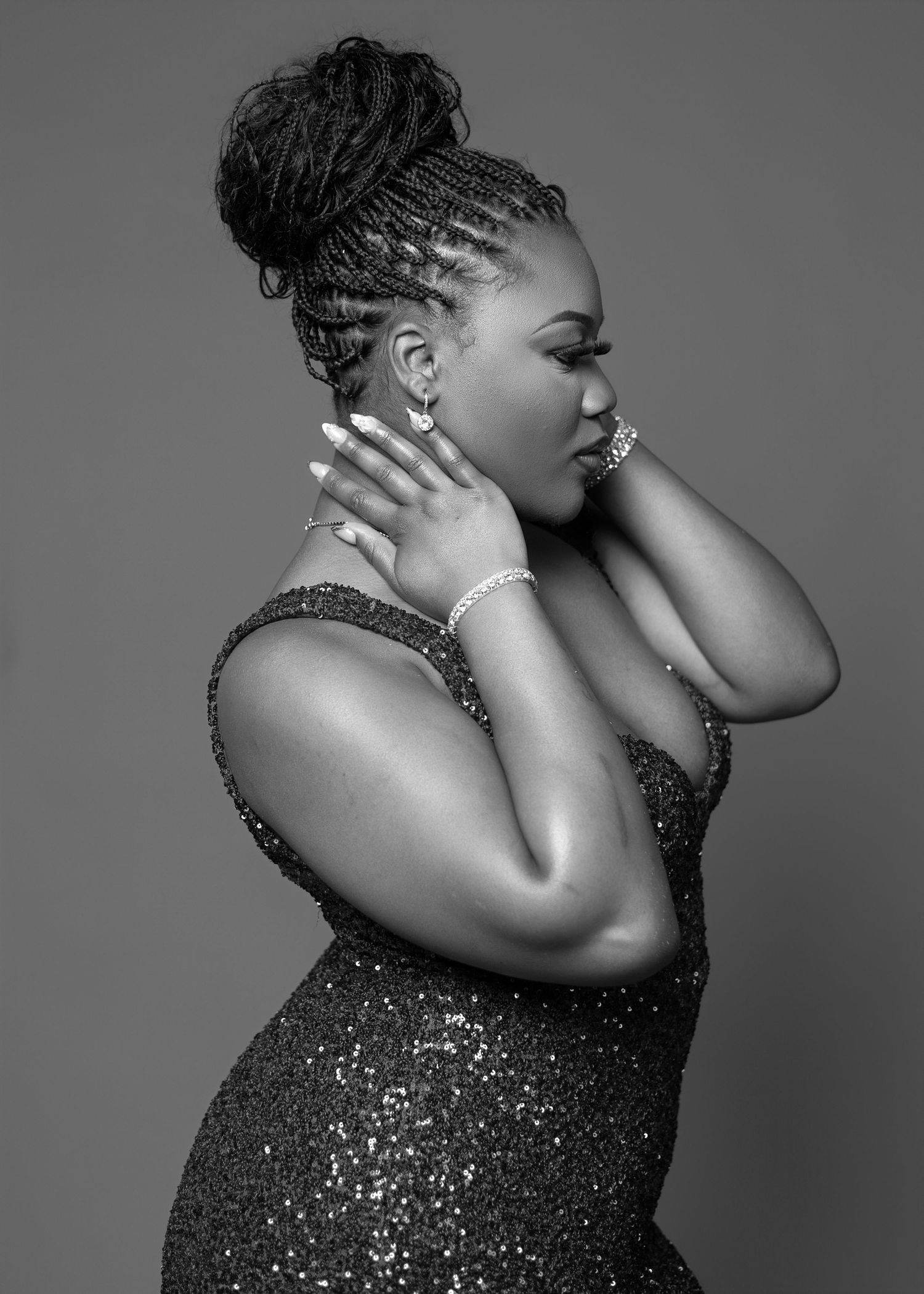 Black and white portrait series showing elegant poses in a glittering formal dress.