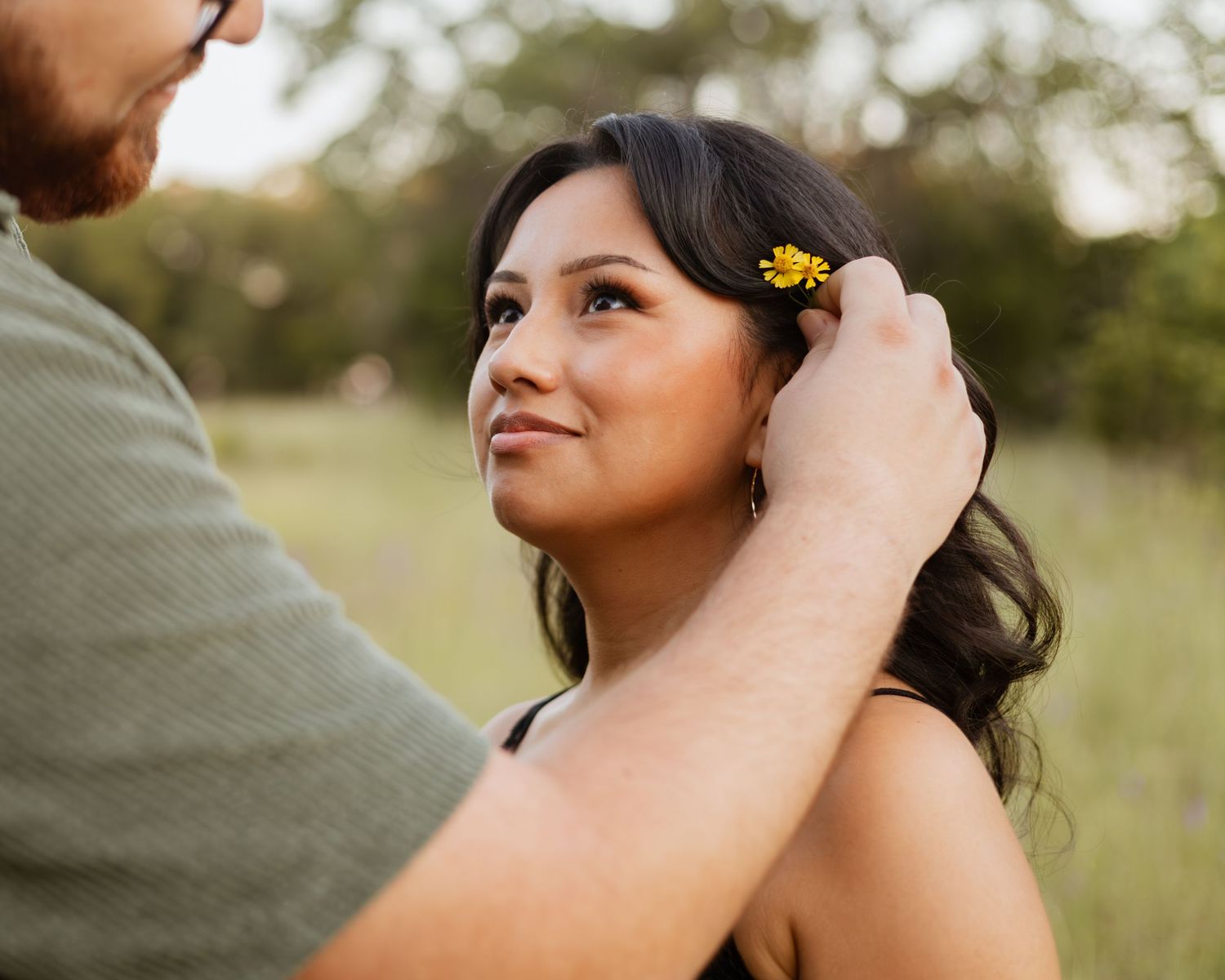 Close-up romantic shots in a sunlit outdoor setting with yellow flowers.