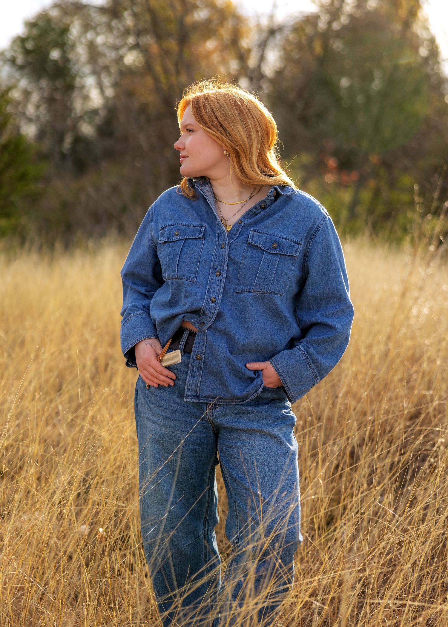 Double denim outfit captured in golden field at sunset.