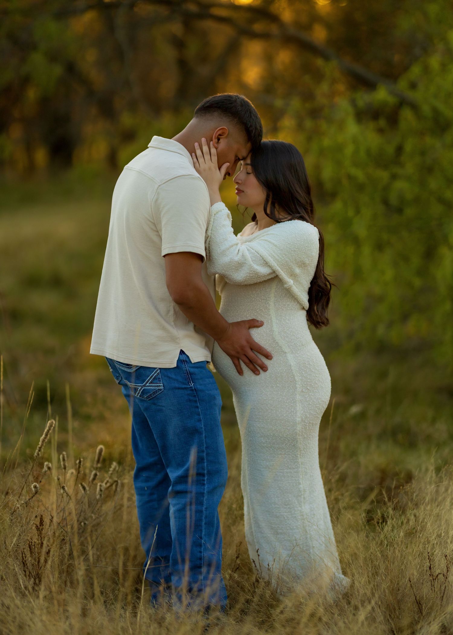 Romantic sequence of a couple embracing in a field during sunset.