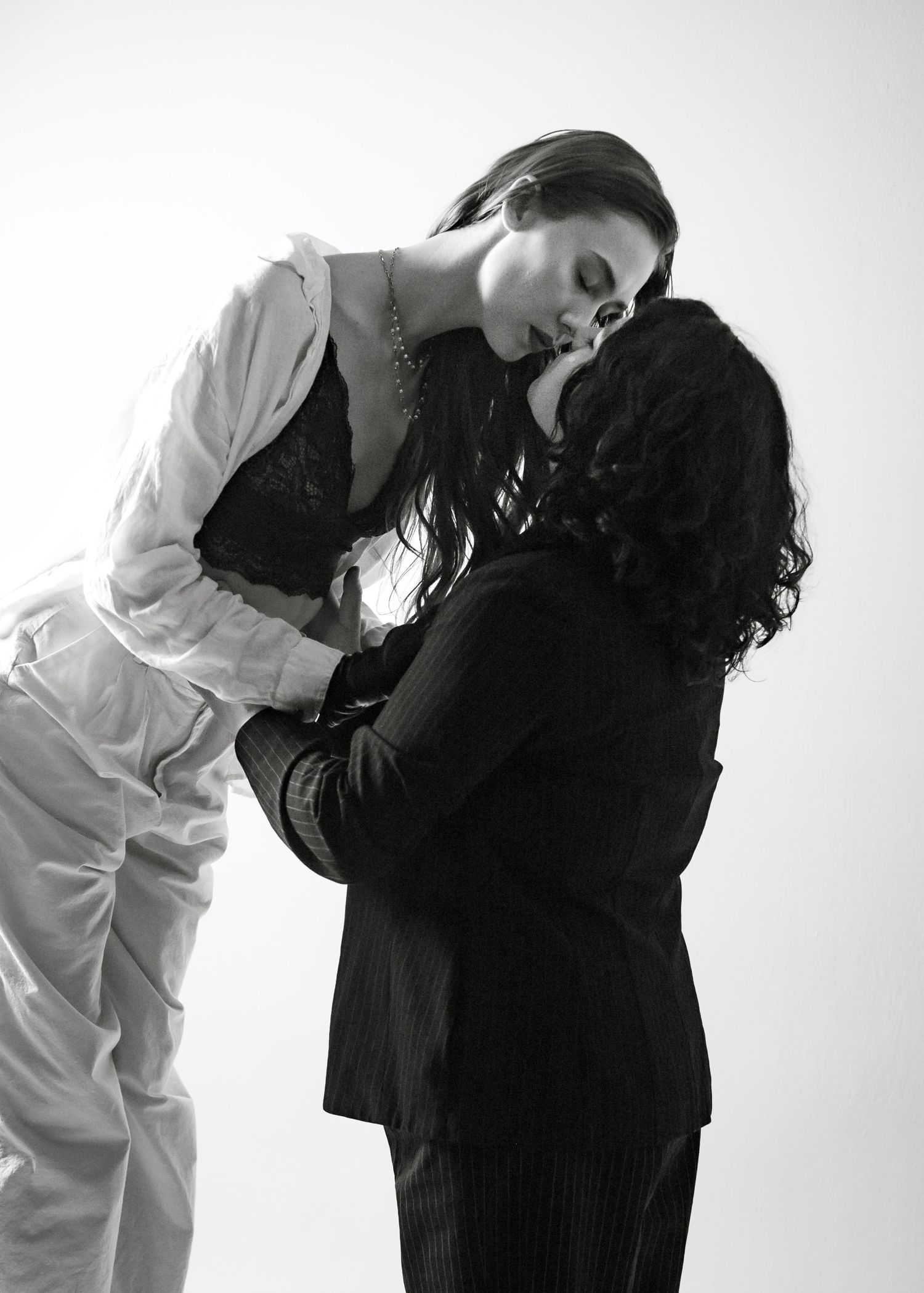 Dramatic black and white photo sequence showing two models in contrasting outfits.