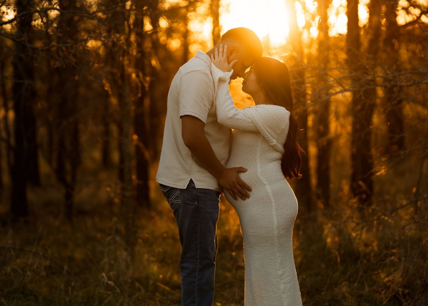 Romantic sunset photoshoot in a forest with warm golden backlighting.