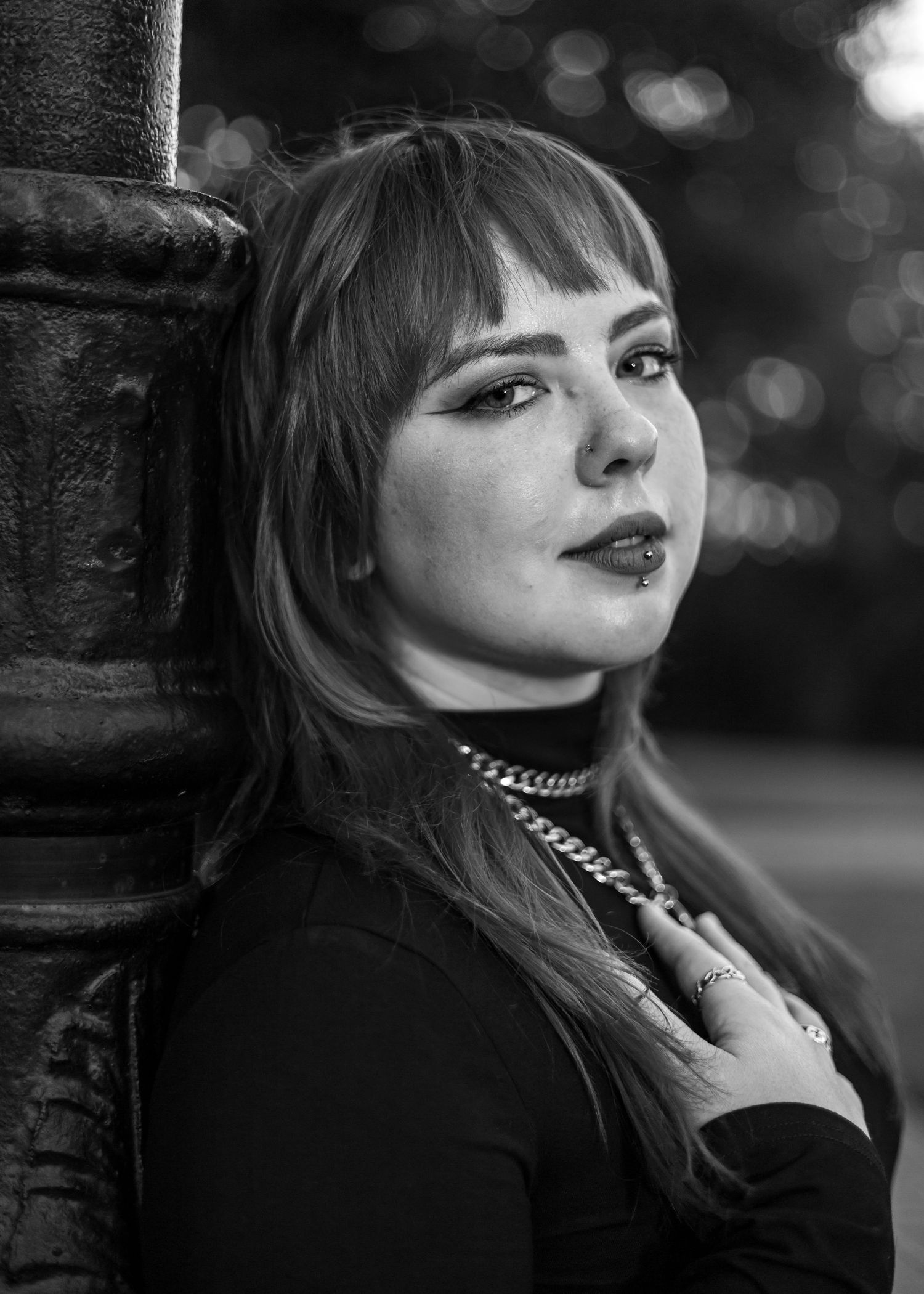 Dramatic black and white portrait series showcasing gothic style with dark lipstick and choker necklace.