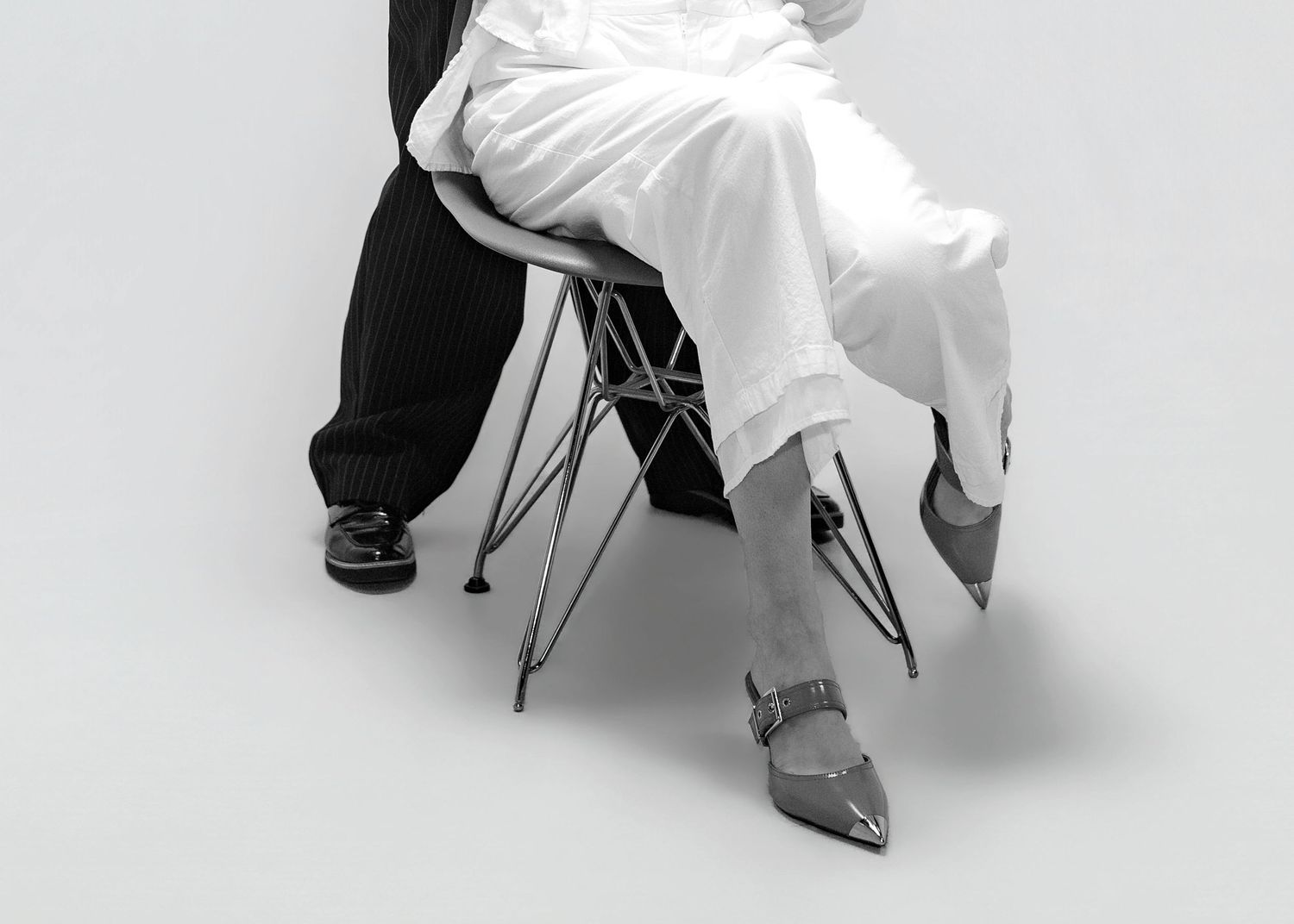 A series of black and white photographs showing a person sitting in a white chair with different leg positions.