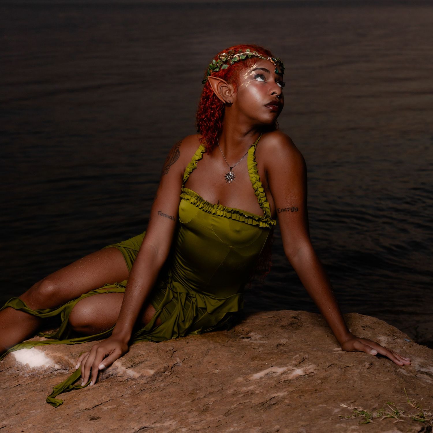 Person in olive green dress poses gracefully by the water's edge at sunset creating a series of artistic silhouettes.