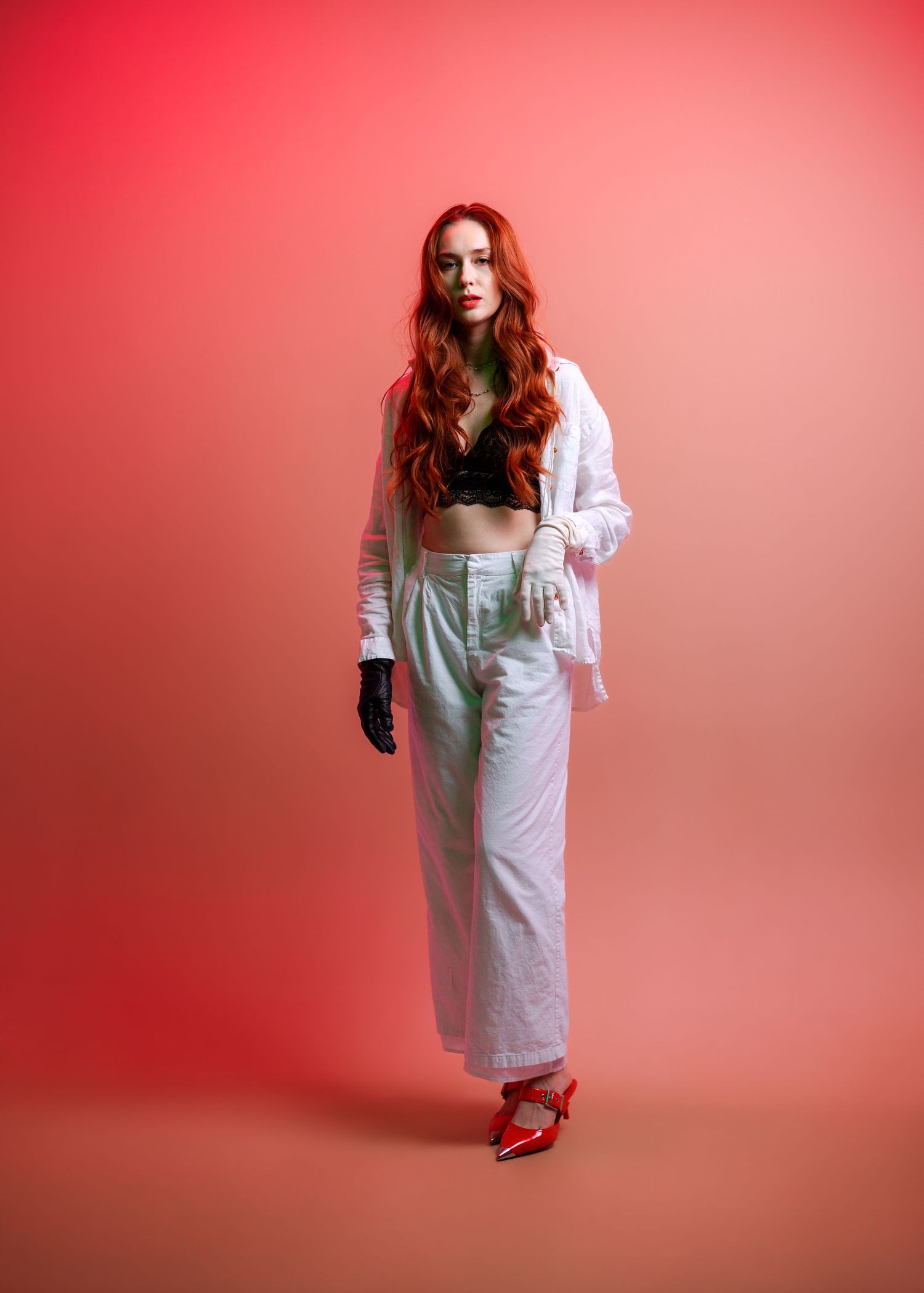 Figure in white dress and red shoes poses against coral background in progressive motion sequence.