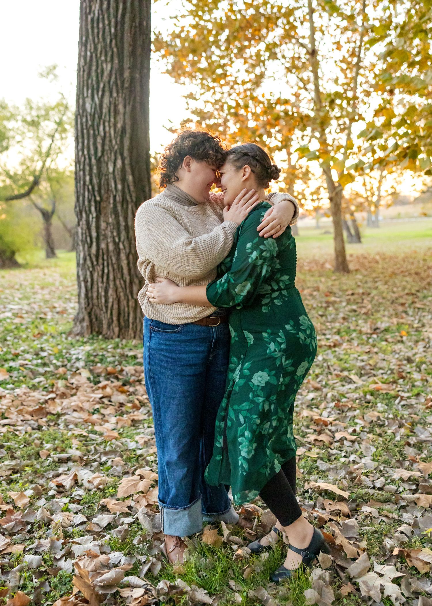 A romantic autumn photoshoot sequence showing a couple embracing among fallen leaves in a park setting.