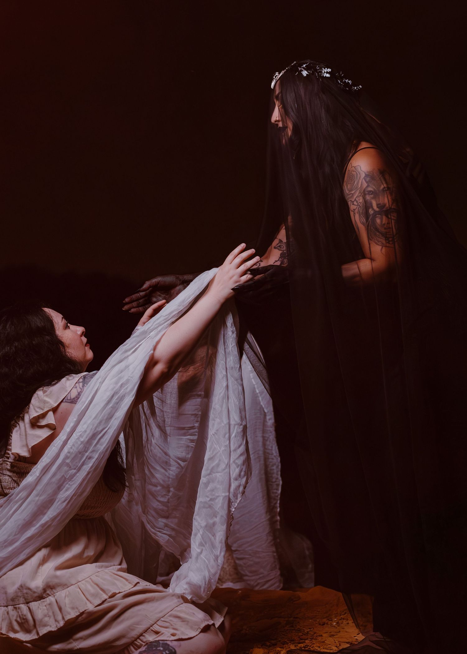 Dramatic sequence of a figure in white fabric moving against a dark background.