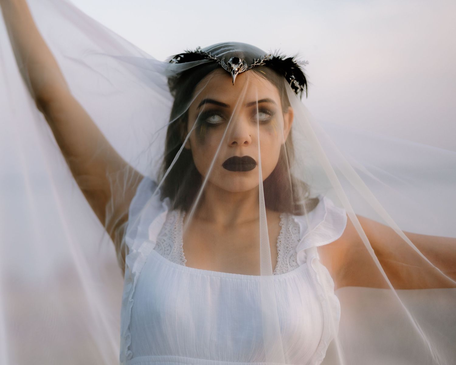 Artistic series of ethereal bridal portraits showing movement through a flowing white veil.