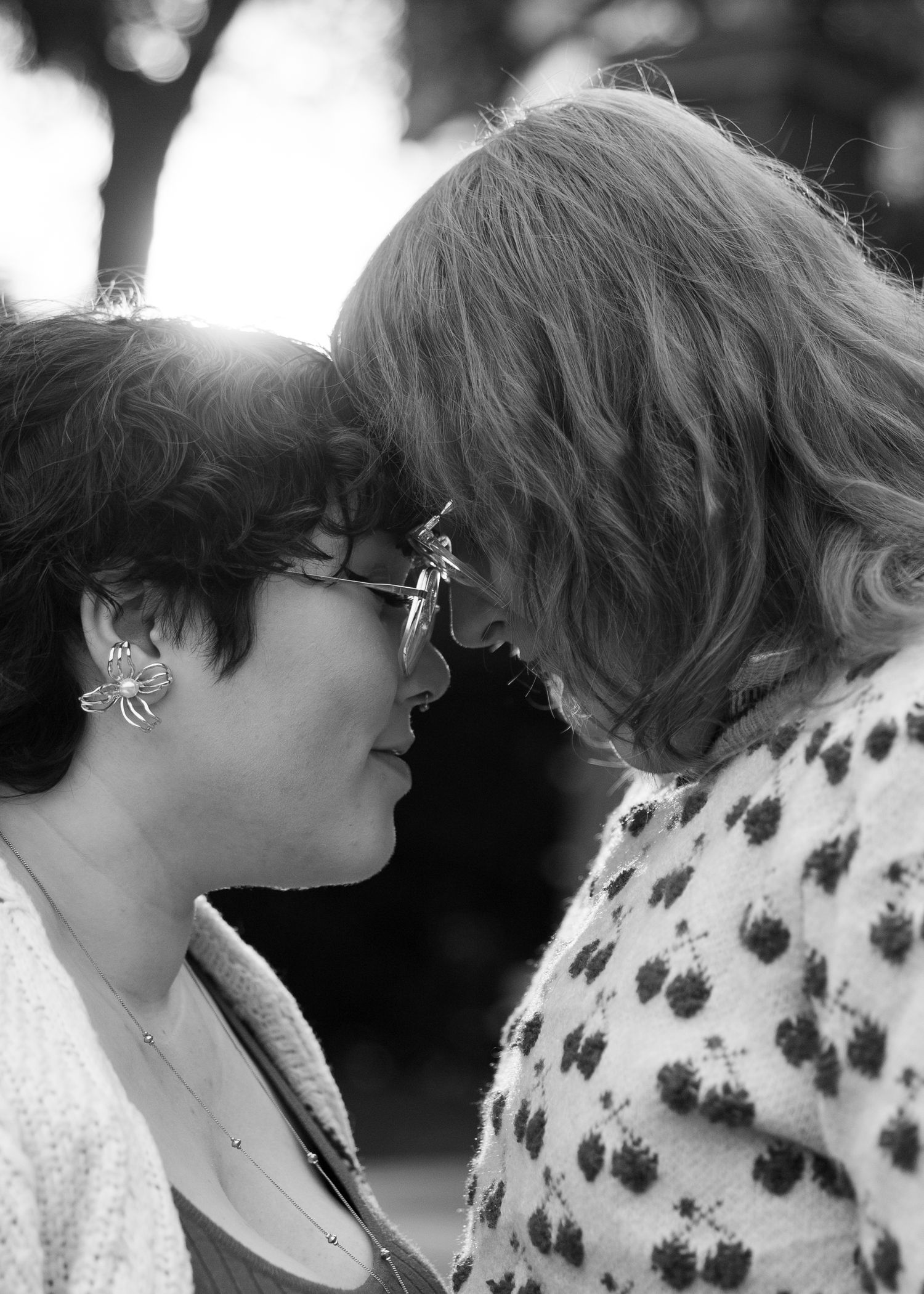 Black and white close-up of two people sharing an intimate moment.