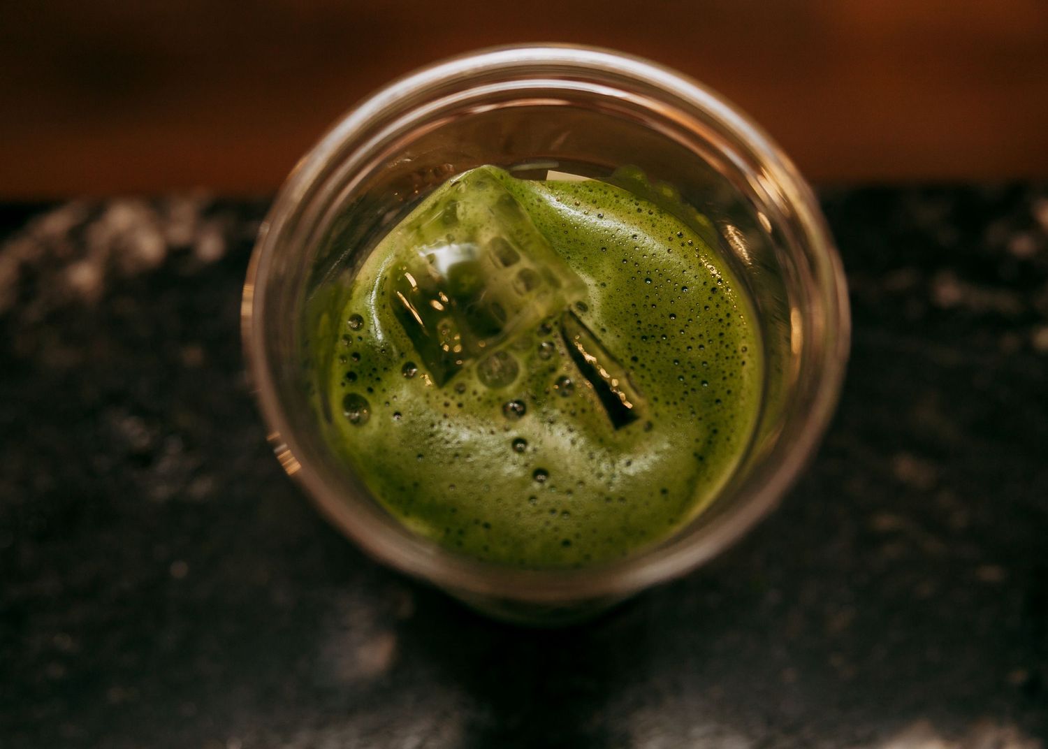 Close-up of a green cocktail with garnish in a glass.